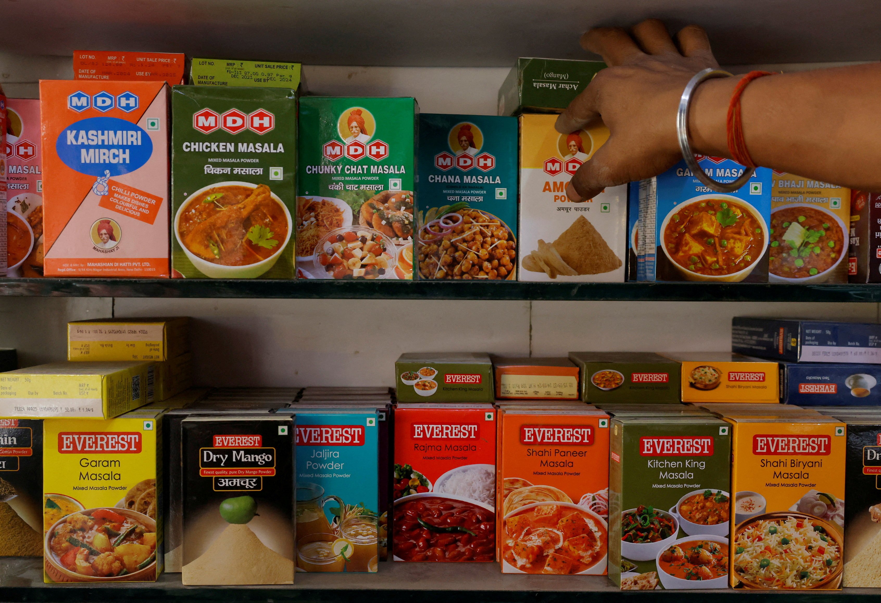 Spice boxes of MDH and Everest on the shelf of a shop at a market in New Delhi. Photo: Reuters
