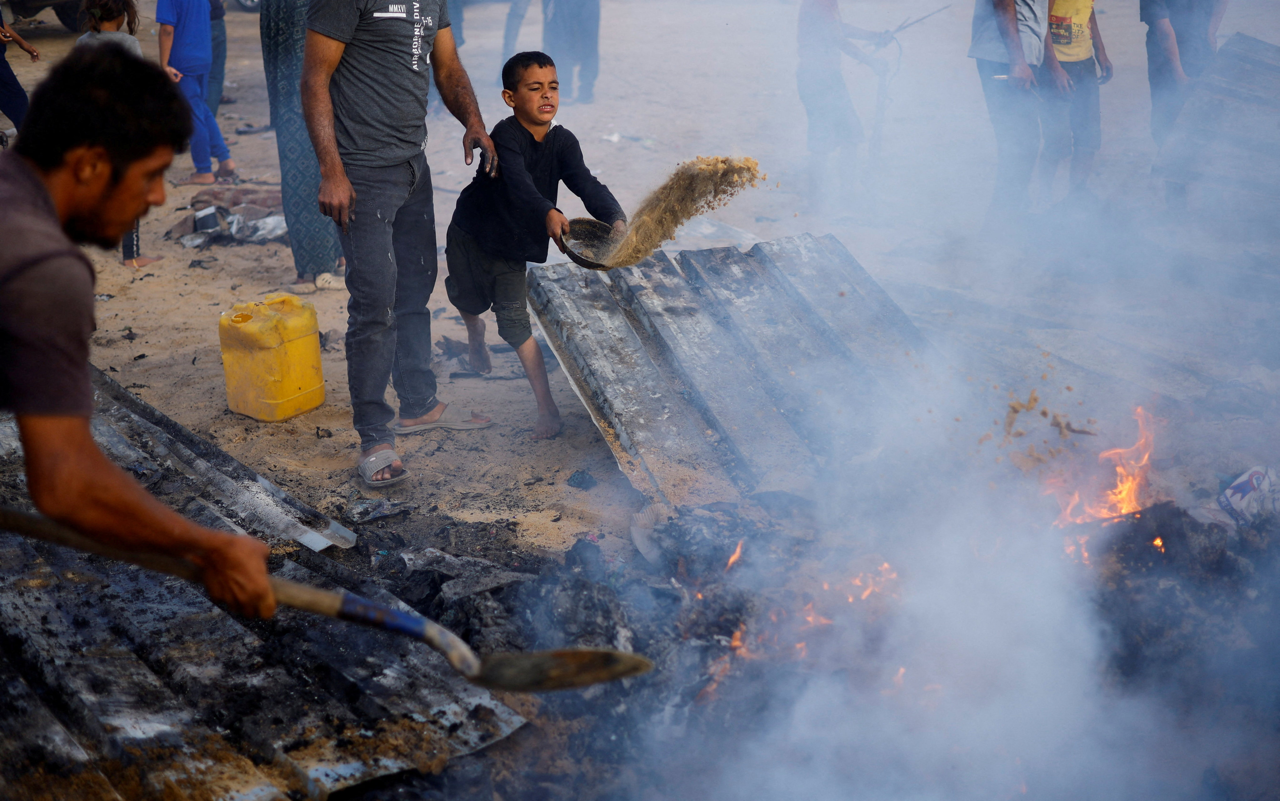 Palestinians put out a fire at the site of an Israeli strike in Rafah, southern Gaza on Monday. Photo: Reuters 