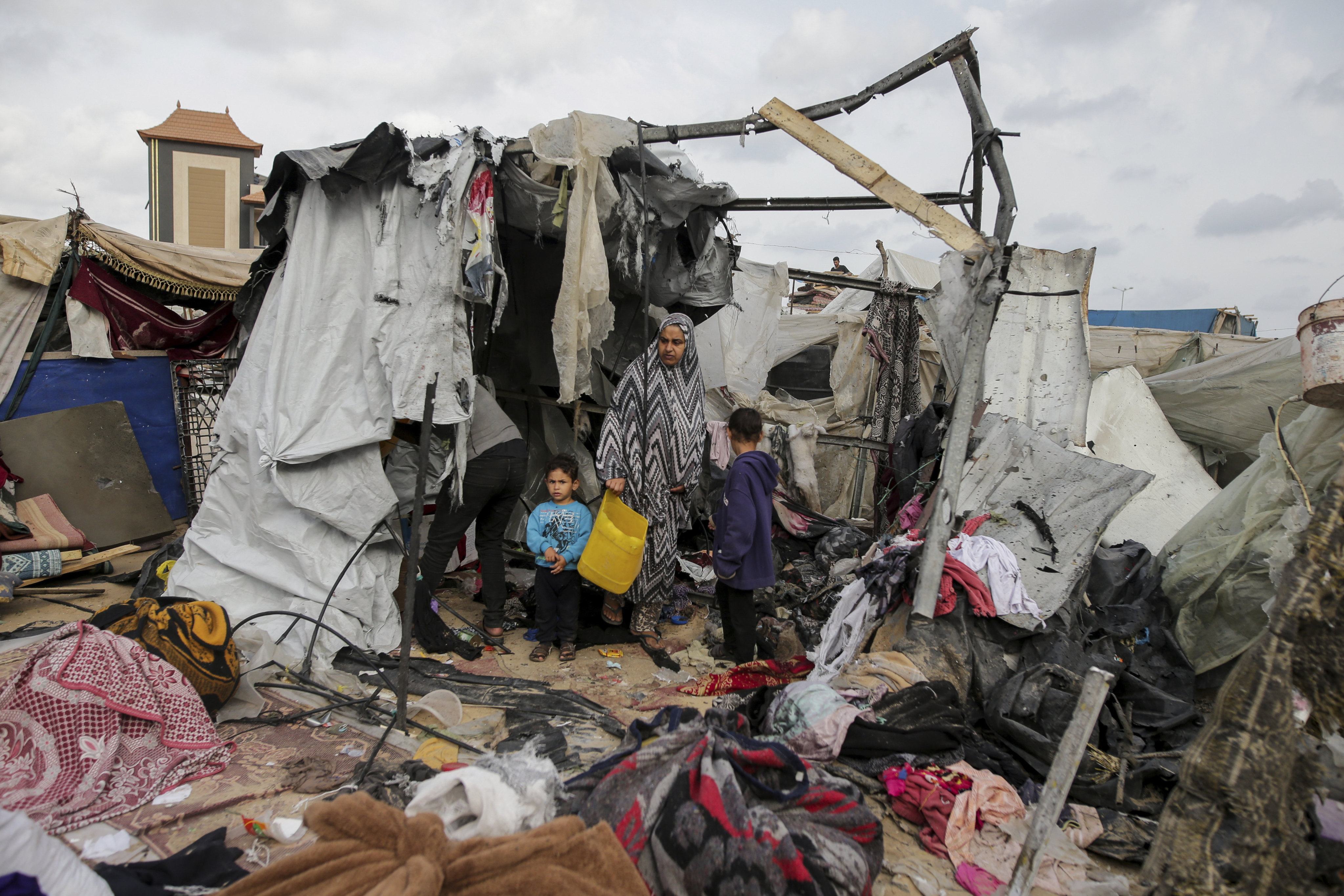 Displaced Palestinians inspect their tents destroyed by Israel’s bombardment. Photo: AP