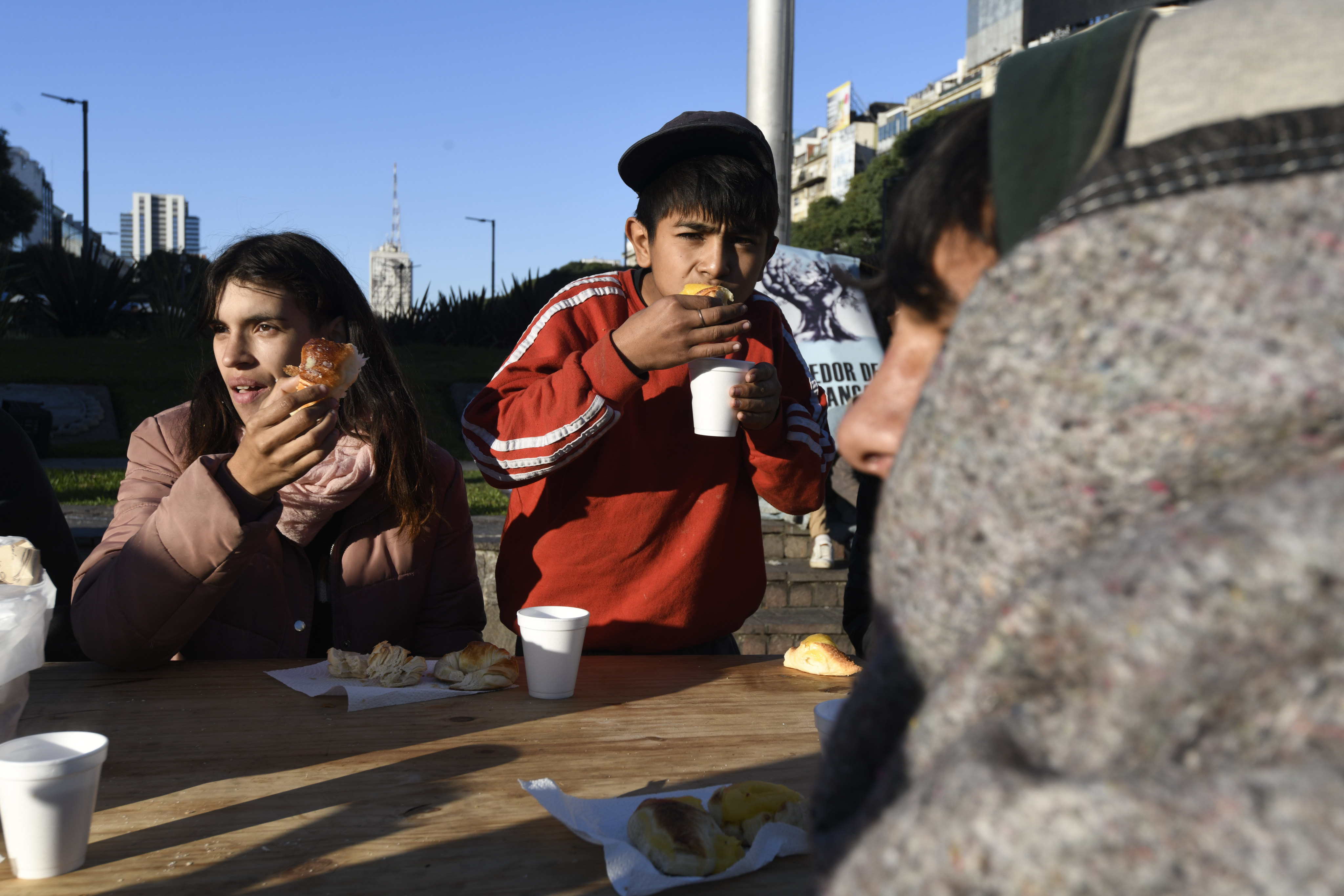 People eat a free breakfast served by a soup kitchen in Buenos Aires, Argentina. Photo: AP 