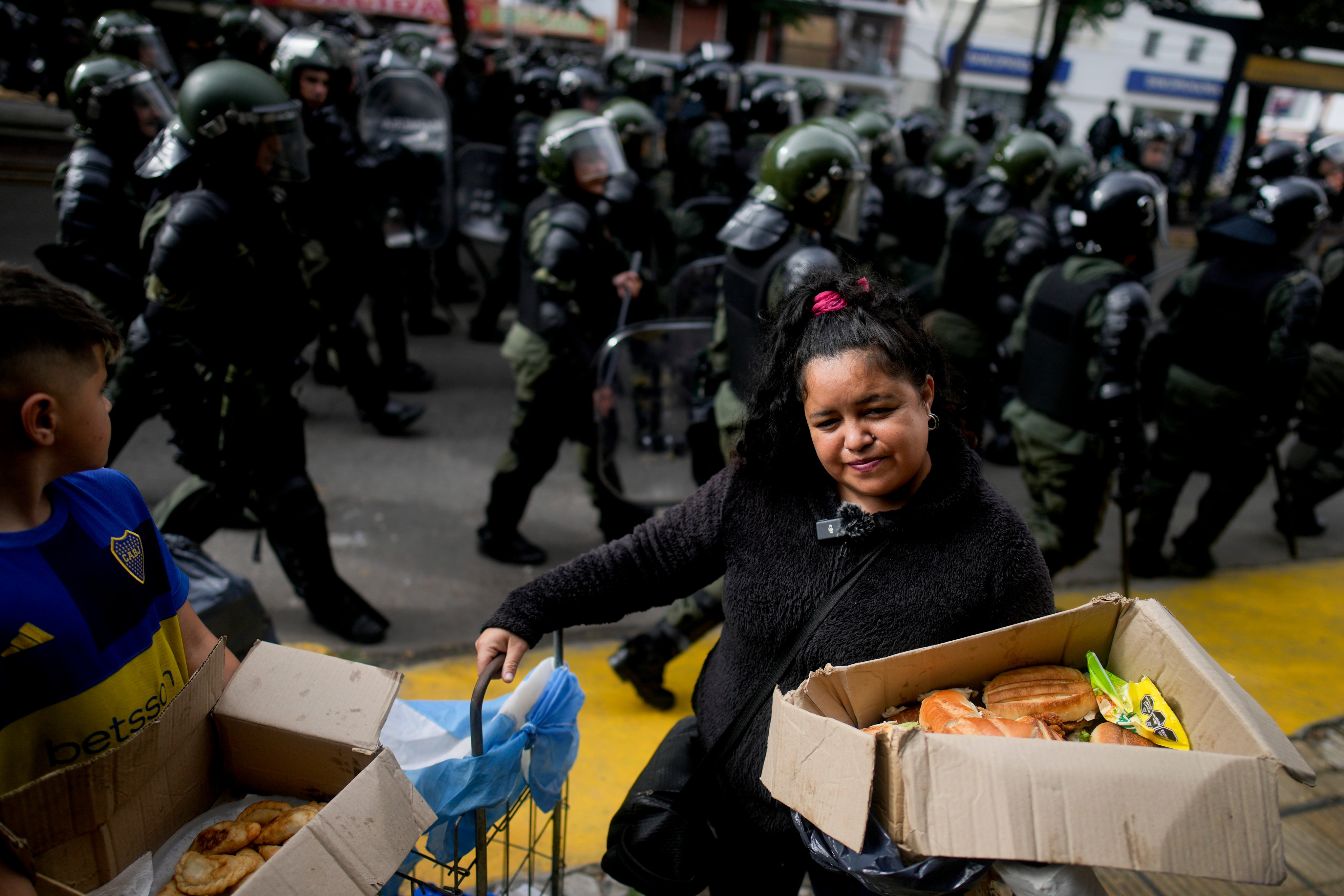 A woman sells sandwiches on the sidelines of a protest against food scarcity at soup kitchens in Buenos Aires, Argentina. Photo: AP