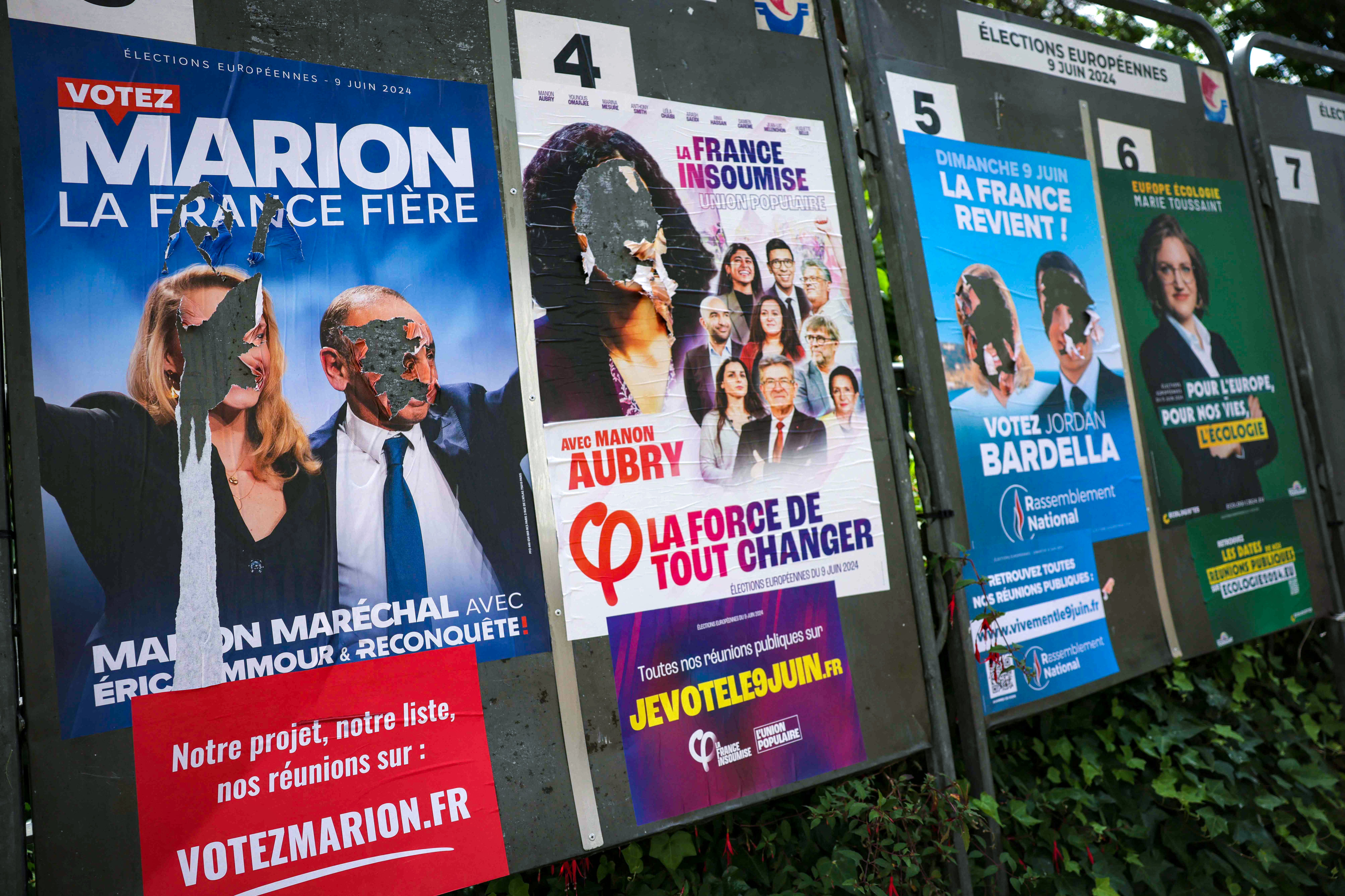 Panels in Paris display campaign posters, many of them defaced, for the 37 political parties and candidates standing in the European election. Photo: AFP