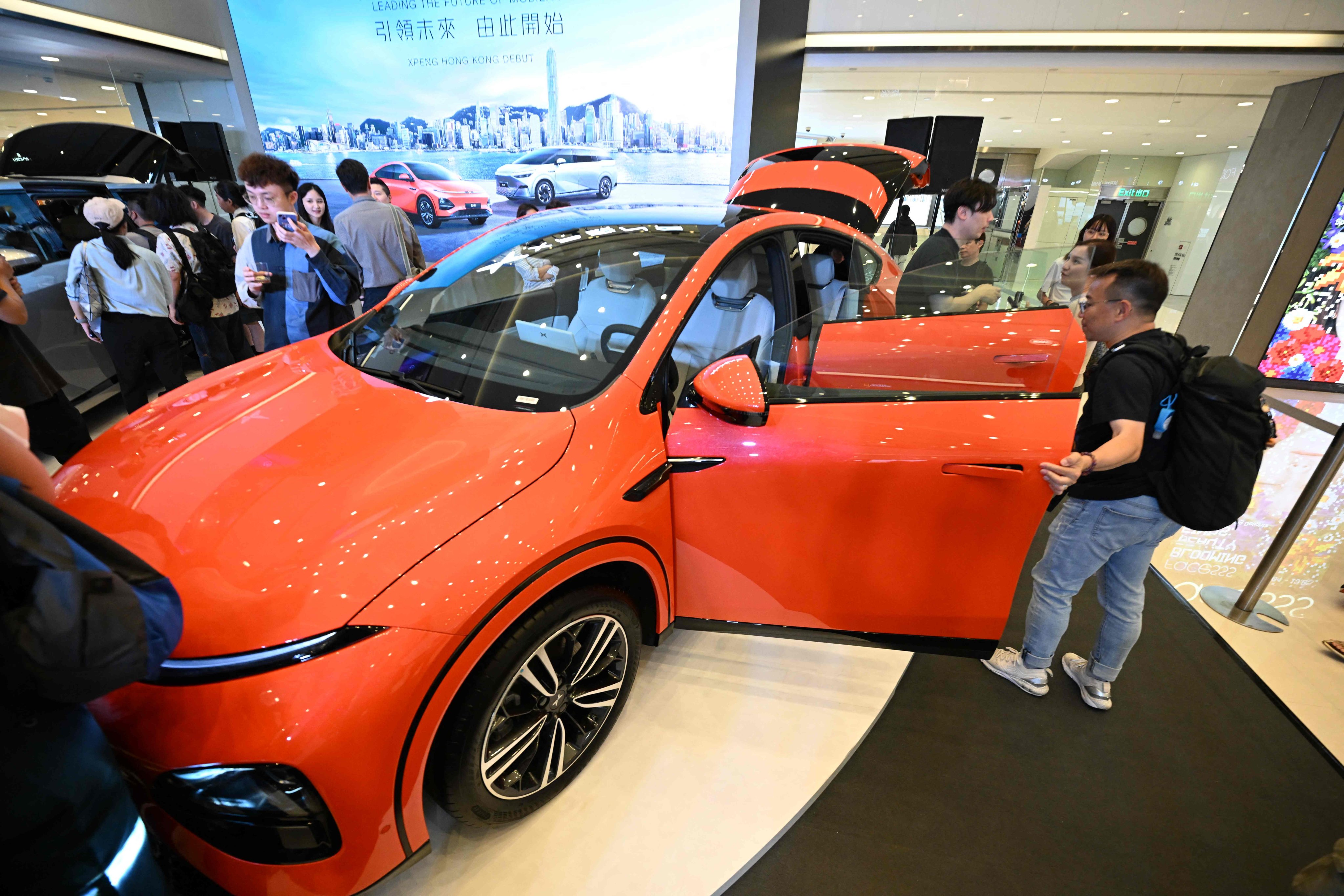 Members of the media look at an Xpeng G6 electric car during the Chinese car brand’s Hong Kong debut. Photo: AFP