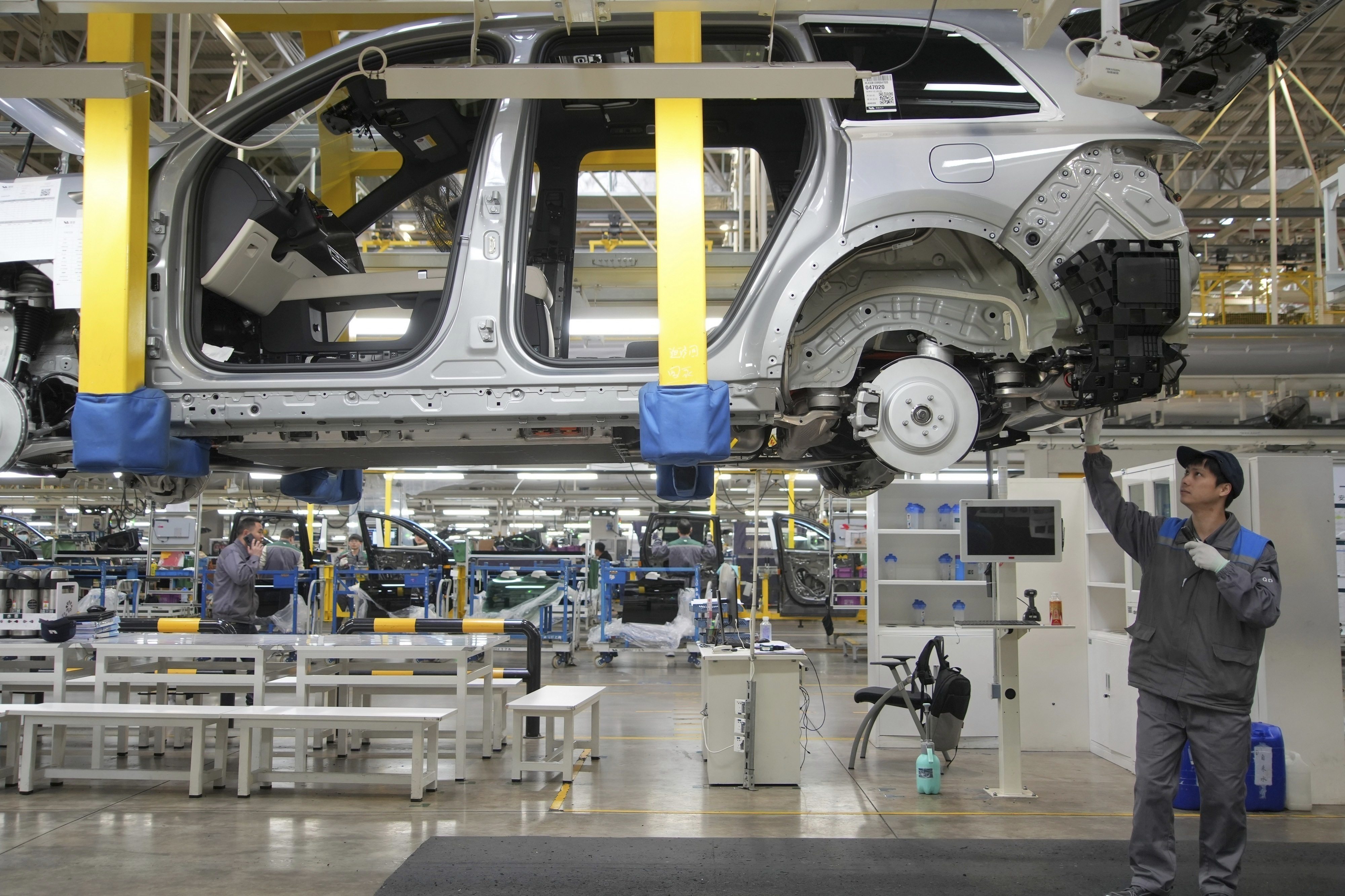 A worker assembles an SUV at a car plant for Li Auto, a major Chinese EV maker, in Changzhou in eastern China’s Jiangsu province on March 27, 2024. Photo: AP