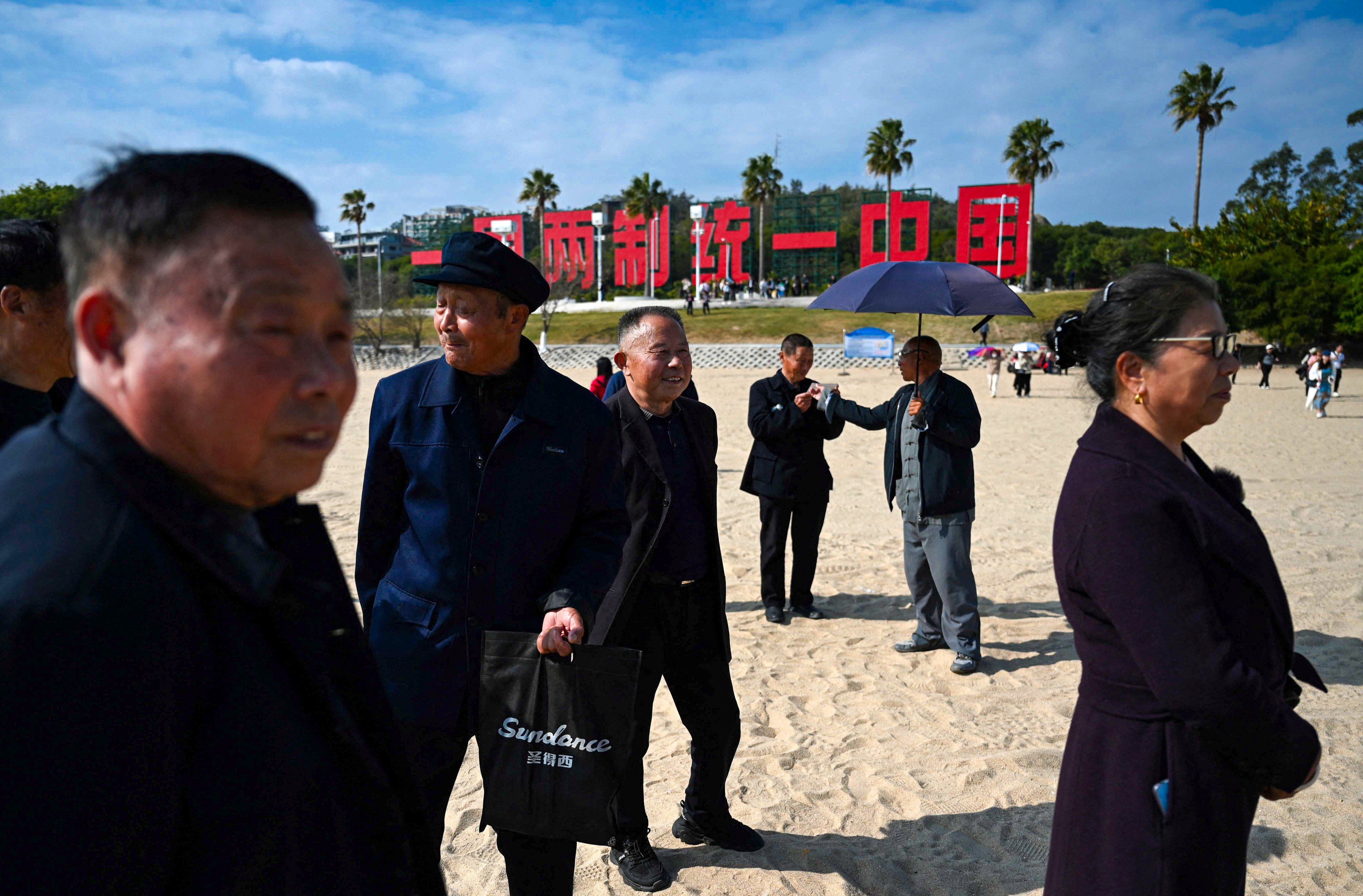 A giant sign reading “One Country, Two Systems, Unify China” is seen on the  beach in Xiamen, Fujian, the closest mainland province to Taiwan. Photo: AFP 