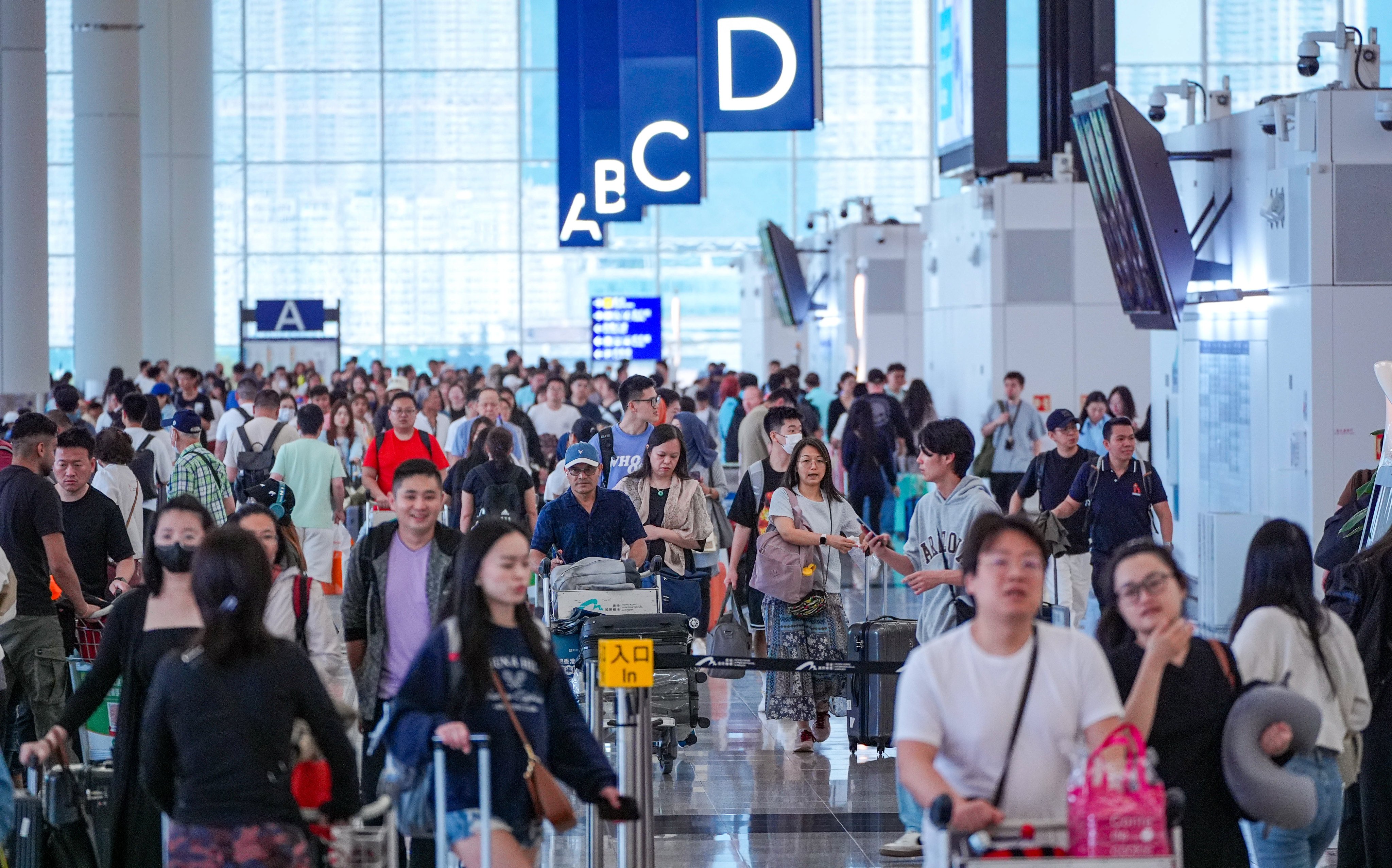 Travellers throng Hong Kong International Airport during the Labour Day Golden Week holidays on May 1, 2024. Photo: Eugene Lee