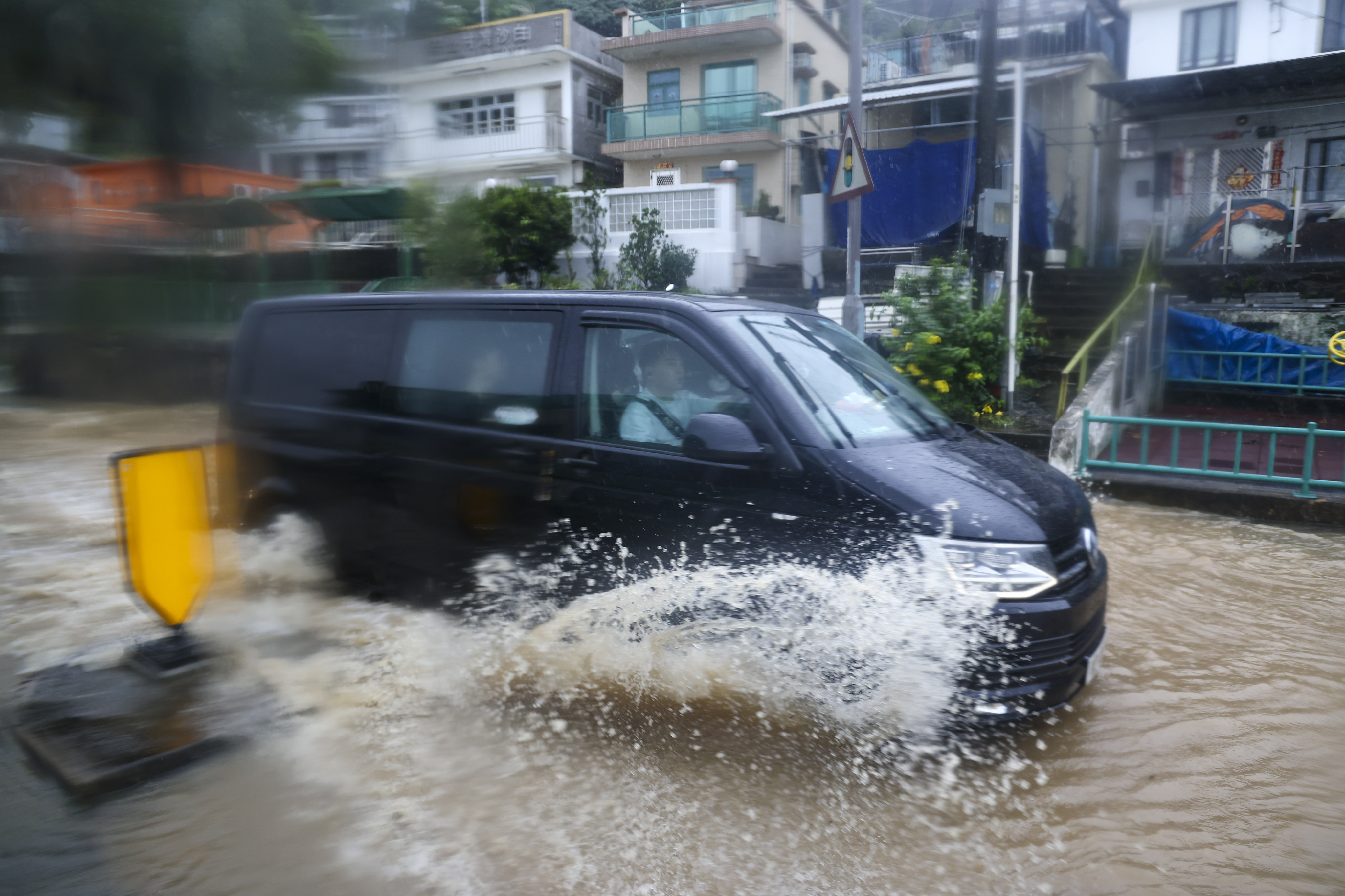 A vehicle sloshes through floodwaters in Sai Kung on May 4. Serious flooding and damage from unusually strong storms underscore Hong Kong’s inadequacies in coping with extreme weather. Photo: Dickson Lee