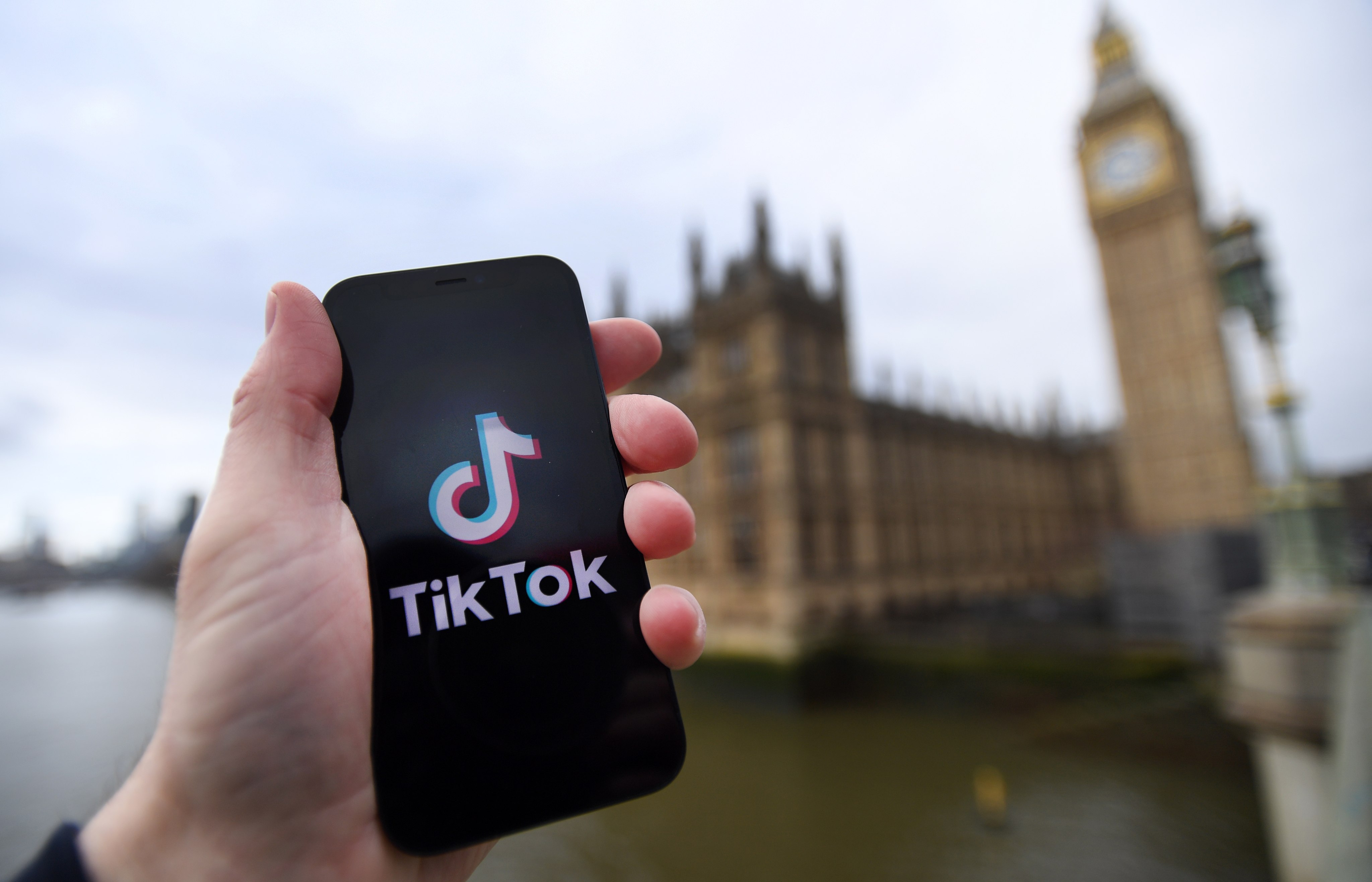 Tik Tok’s logo on a smartphone in front of the British parliament in London. Photo:  EPA-EFE