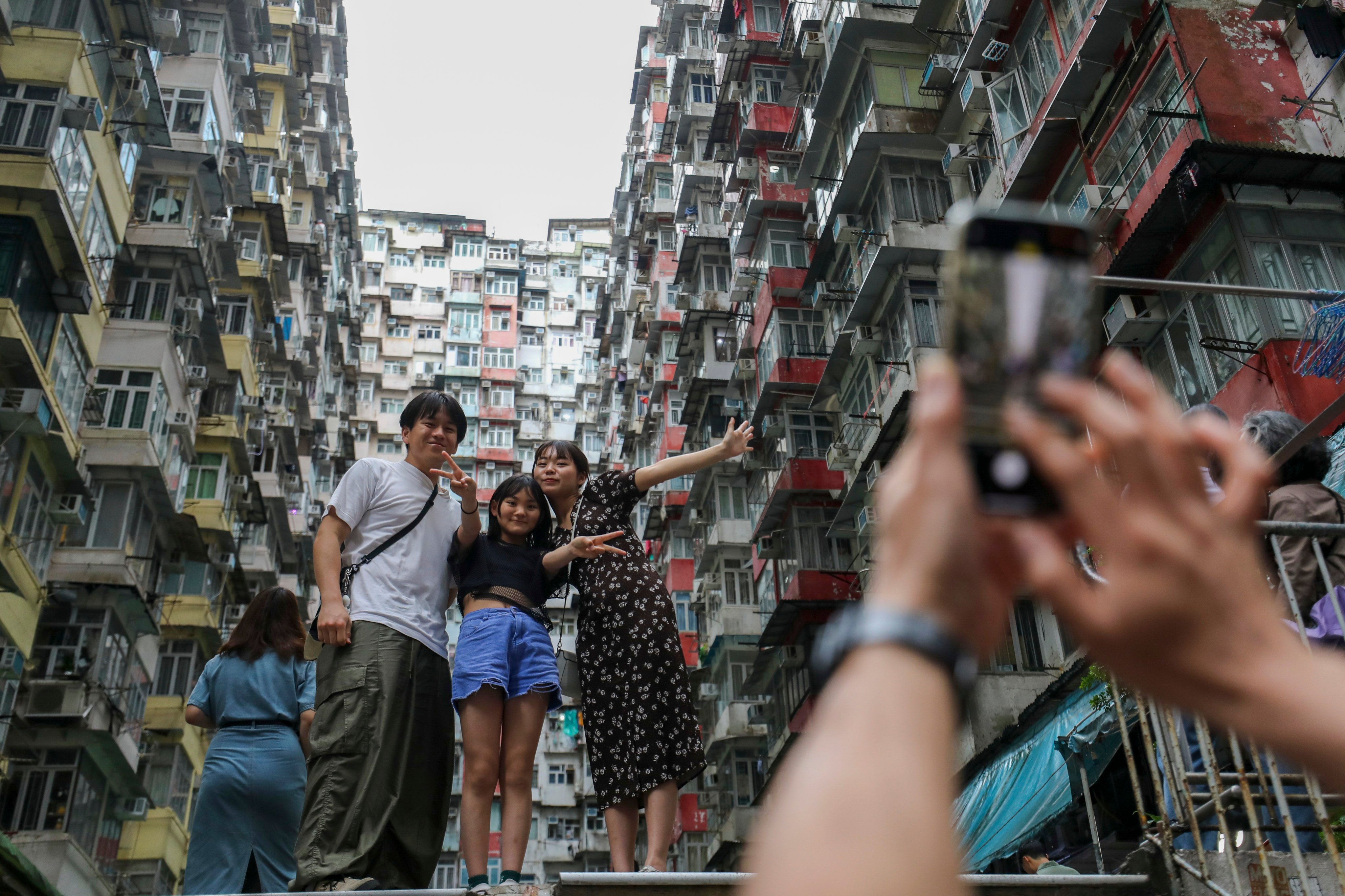 Tourists pose at Yick Cheong Building (aka Monster Building) in Quarry Bay on May 4. The consultation for the Tourism Blueprint 2.0 that ends in mid-June should look in particular at supporting the digitising of tourist experiences. Photo: Xiaomei Chen