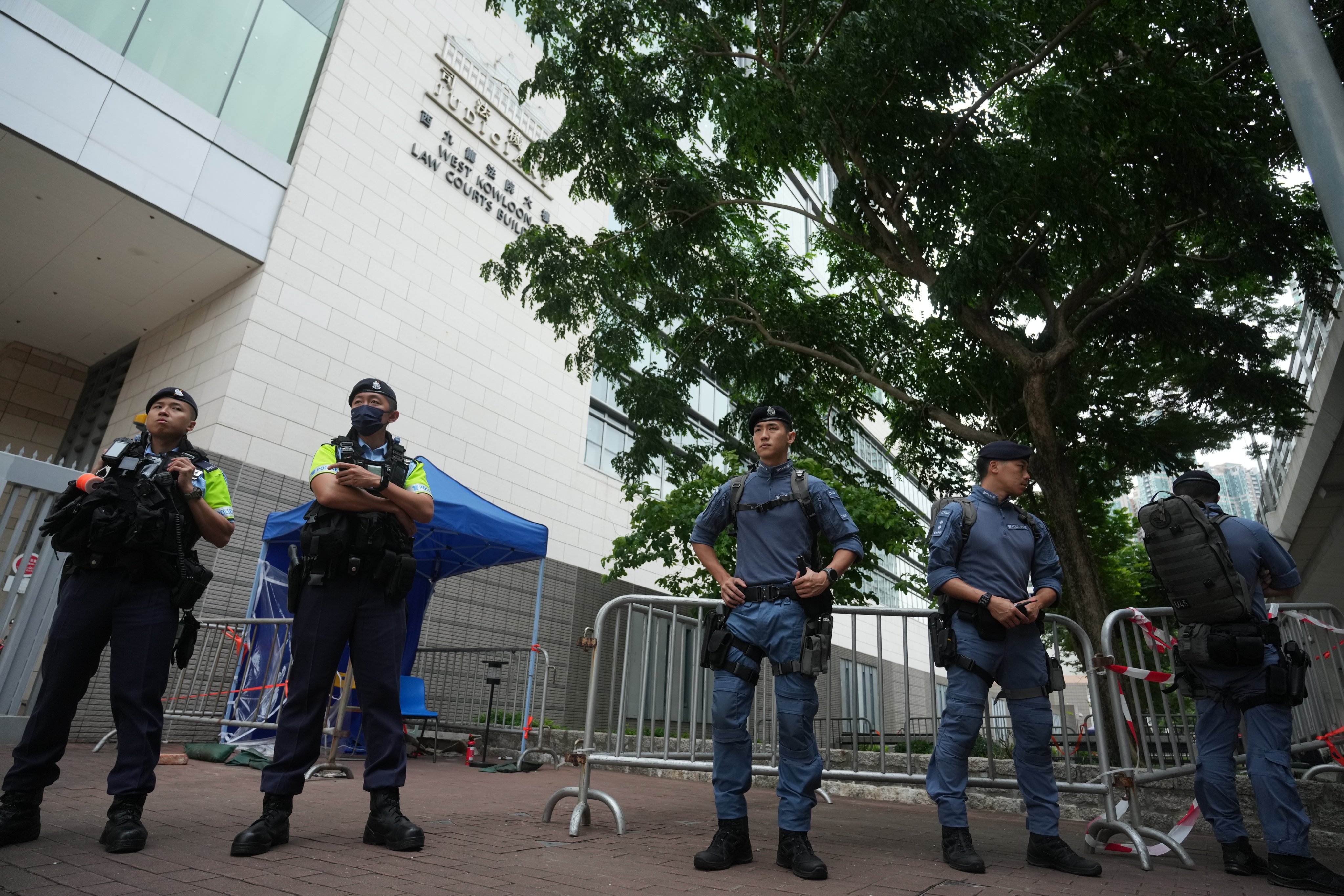 Police officers stand guard outside West Kowloon Court on Thursday. Photo: Sam Tsang