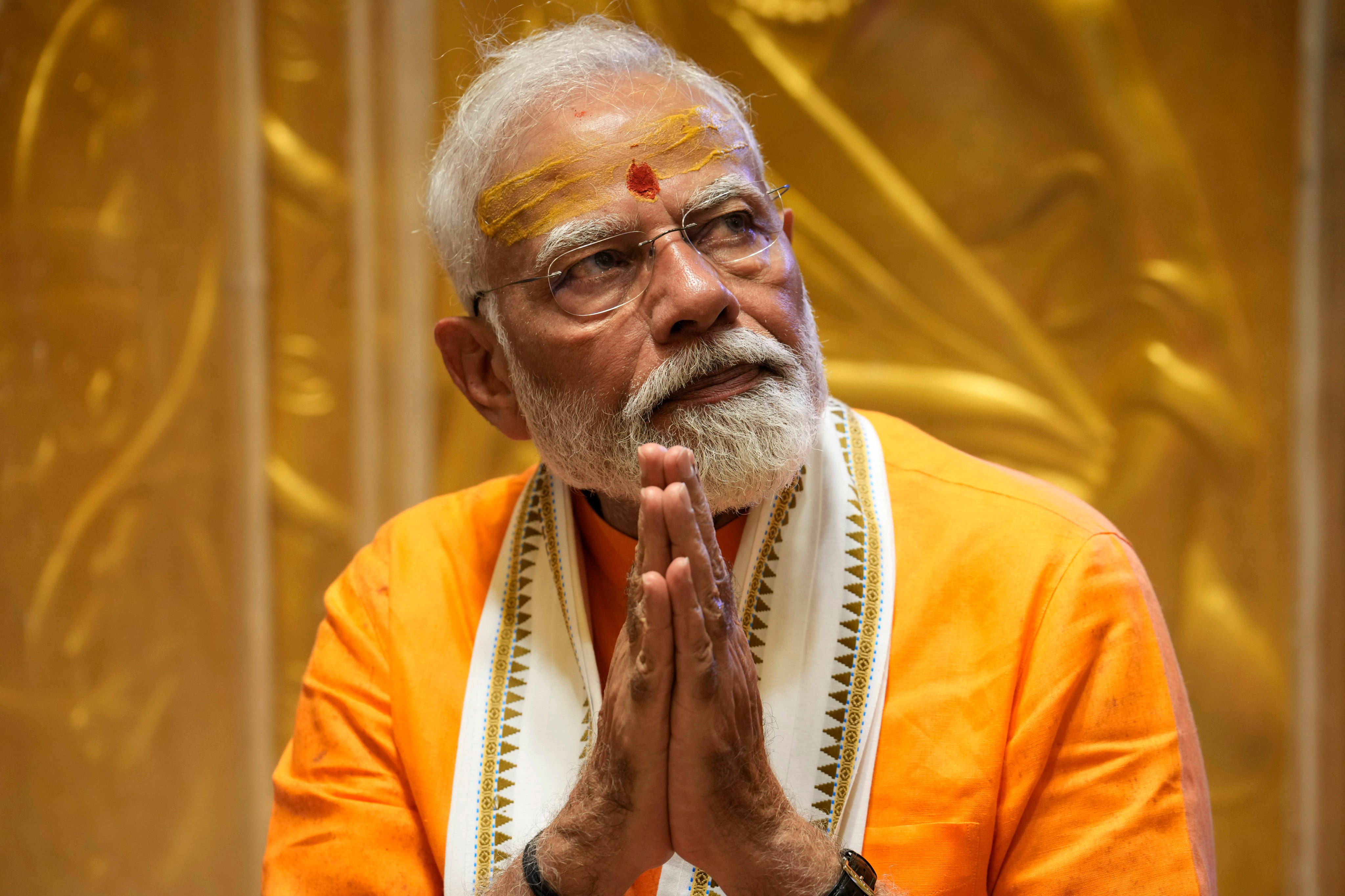 Indian Prime Minister Narendra Modi prays at Kashi Vishwanath Temple after a roadshow in Varanasi, India. Photo: AP