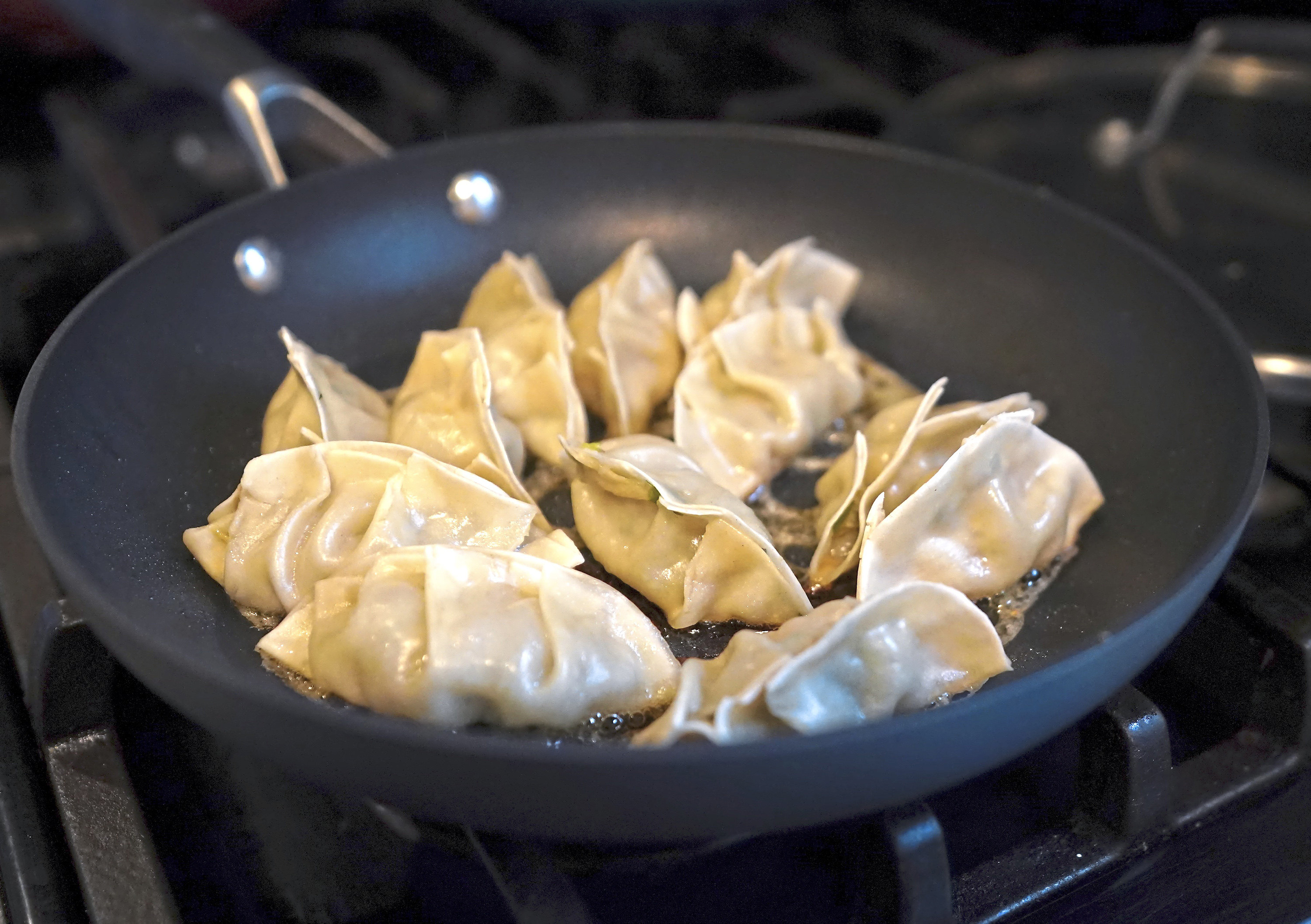 Home-made gyoza dumplings frying. Rie McClenny missed them so much during a year abroad in rural America she began making her own. Now she’s a YouTube regular with her own cookbook. Photo: TNS