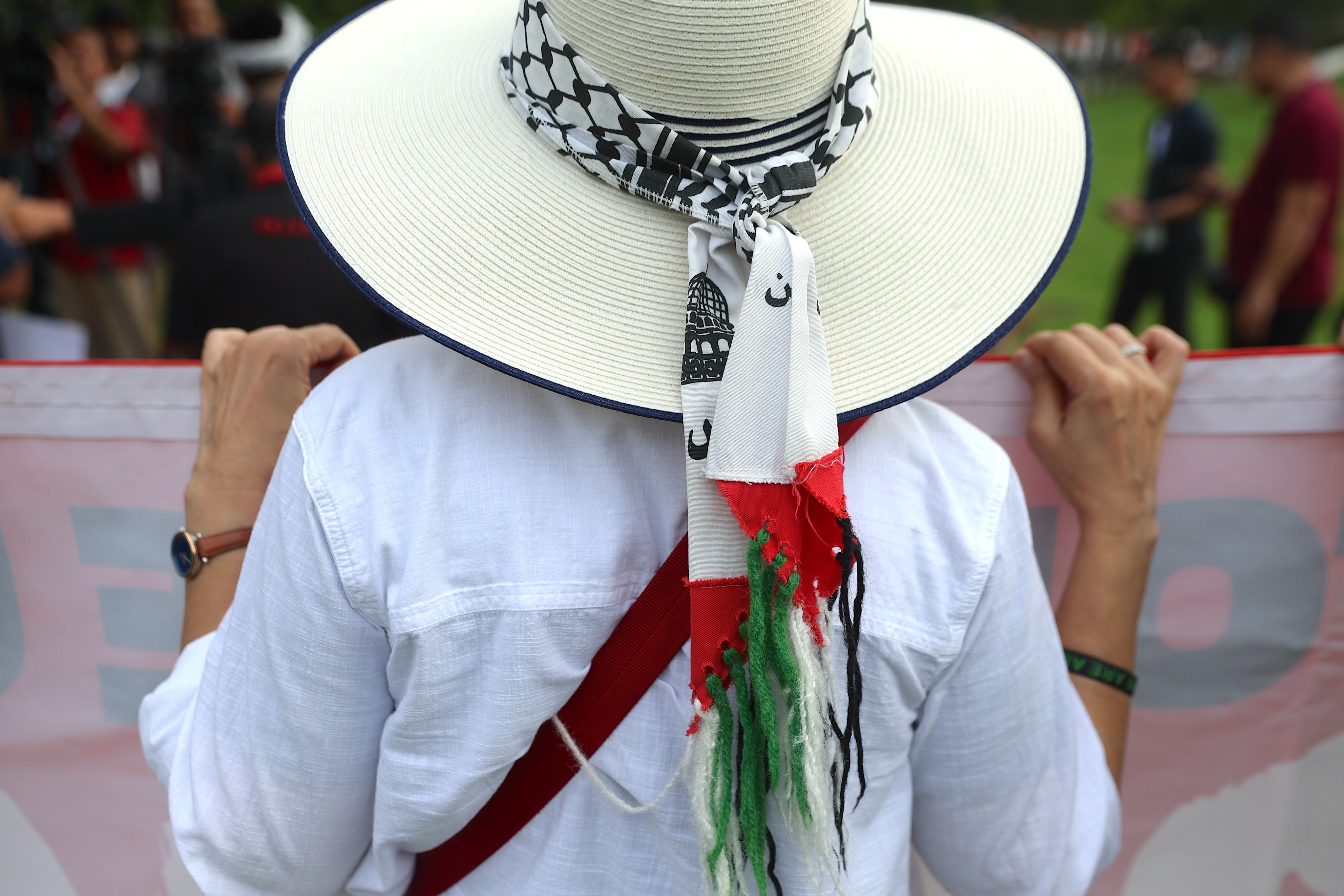 A woman wearing a hat with a Palestinian scarf attends a protest against arms manufacturers supplying weapons to Israel, outside the venue of a defence services expo in Kuala Lumpur on May 7. Malaysia has been one of the most vocal supporters of the Palestinian cause since the war in Gaza erupted last October. Photo: EPA-EFE