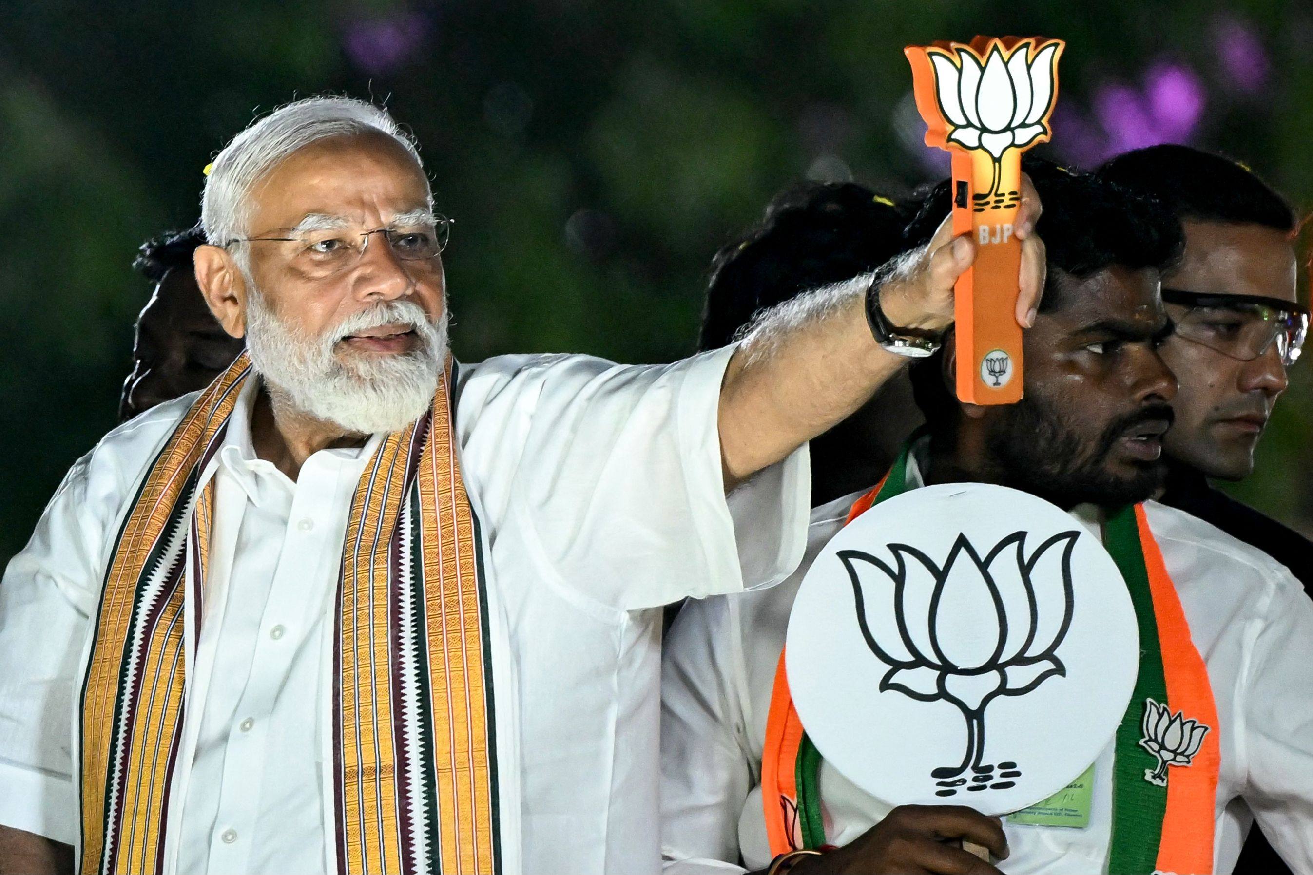 Narendra Modi, India’s Prime Minister and leader of the ruling Bharatiya Janata Party, holds the party symbol during a campaign rally. Photo: AFP/File