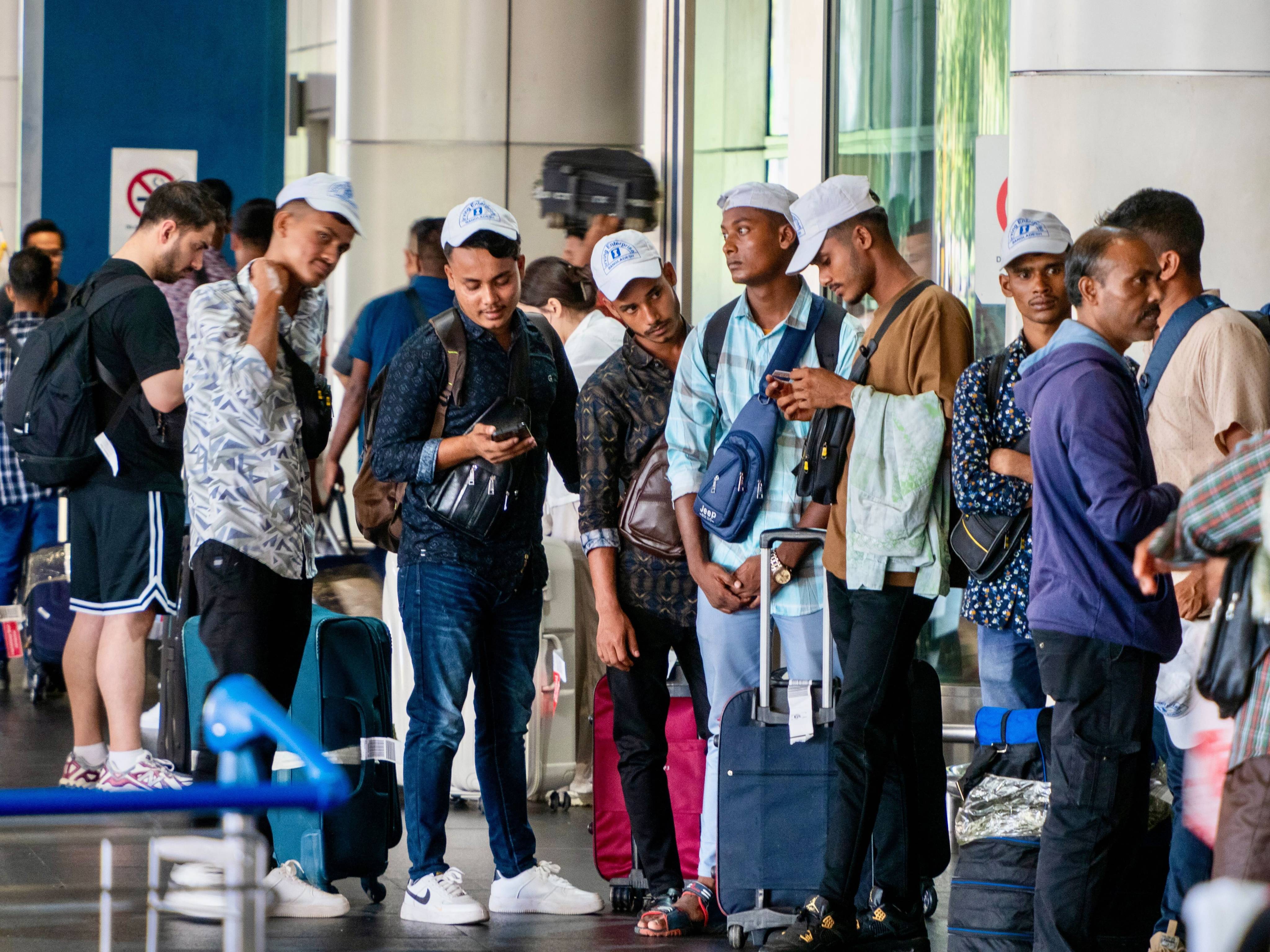 Bangladeshis congregating at the Kuala Lumpur International Lumpur as they rush to beat a May 31 deadline imposed by Malaysia’s government for legal work registration.  Photo: Hadi Azmi
