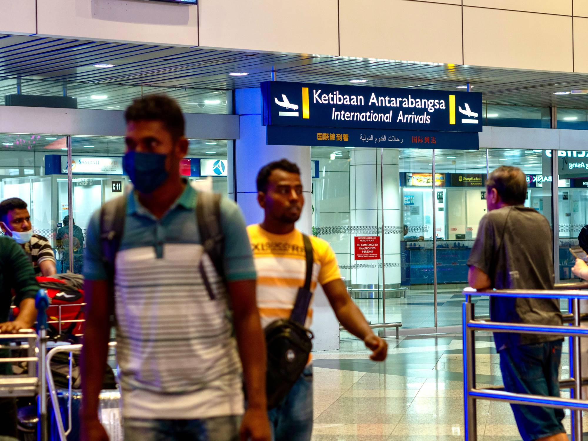 Bangladeshis arriving at the Kuala Lumpur International Lumpur as they rush to beat a May 31 deadline imposed by Malaysia’s government for legal work registration. Photo: Hadi Azmi