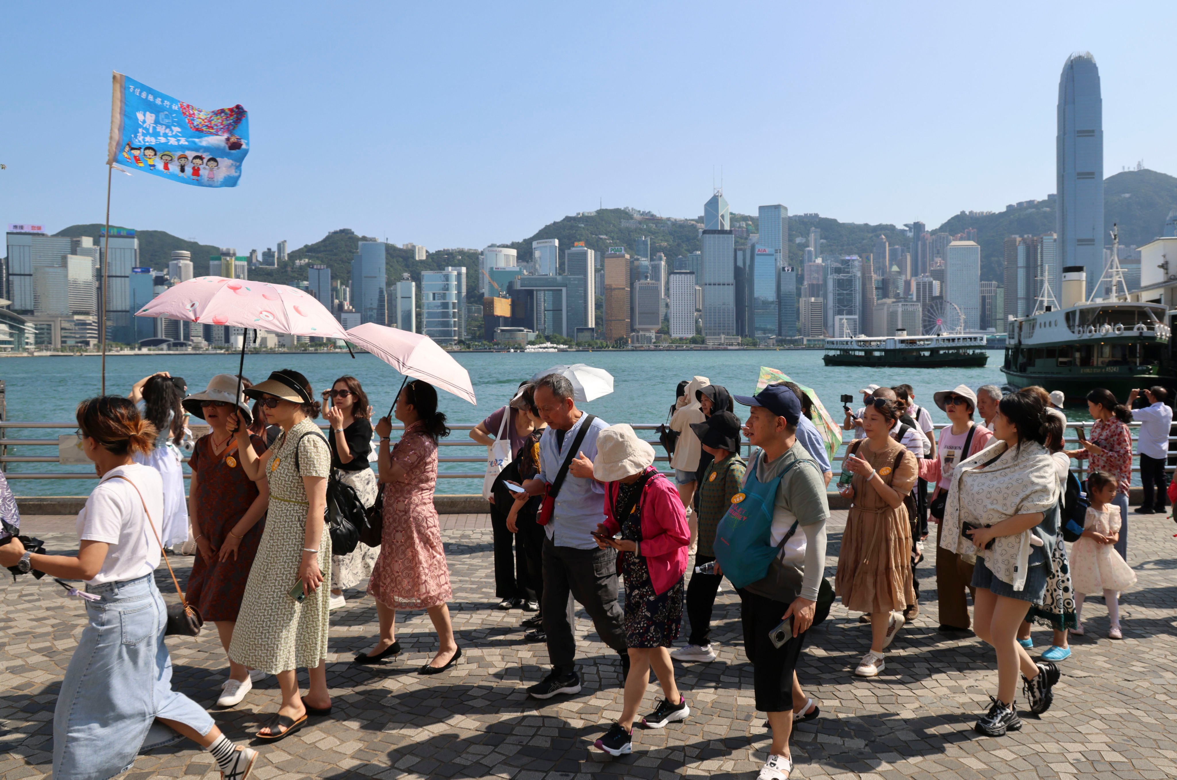 Tourists take in the waterfront at Tsim Sha Tsui. A report from the China Tourism Academy released last week looked at the emphasis Hong Kong put on bringing in big spenders. Photo: Jelly Tse