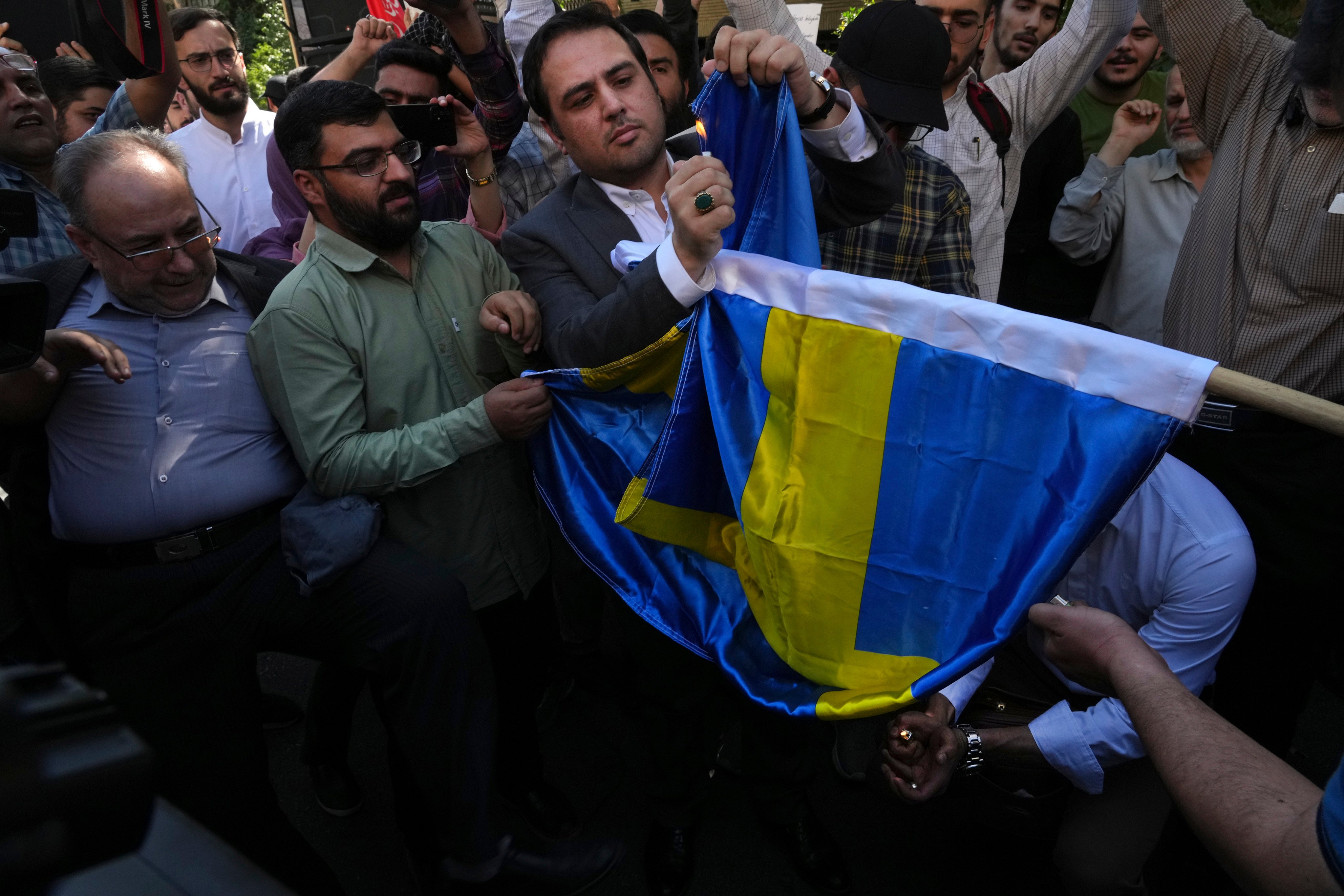 Protesters burn a Swedish flag in Tehran last year. Swedish intelligence has accused Iran of “using criminal networks in Sweden to carry out acts of violence”. Photo: AP