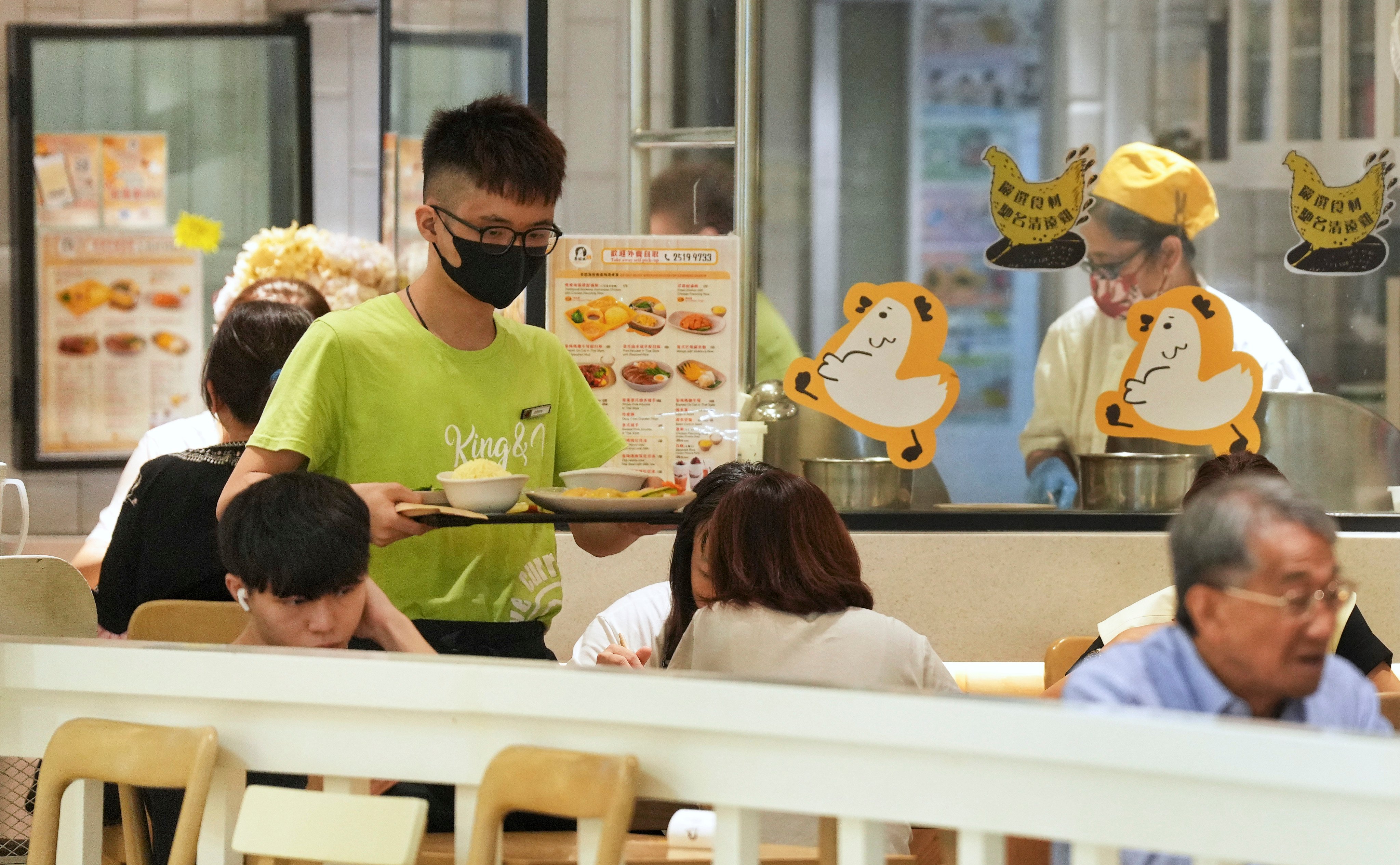 A server delivers food to customers in 2023. 
The behaviour of workers in restaurants and the wider service industry has come under scrutiny amid the Hong Kong government’s efforts to improve the city’s standing as a tourism destination. Photo: Elson Li
