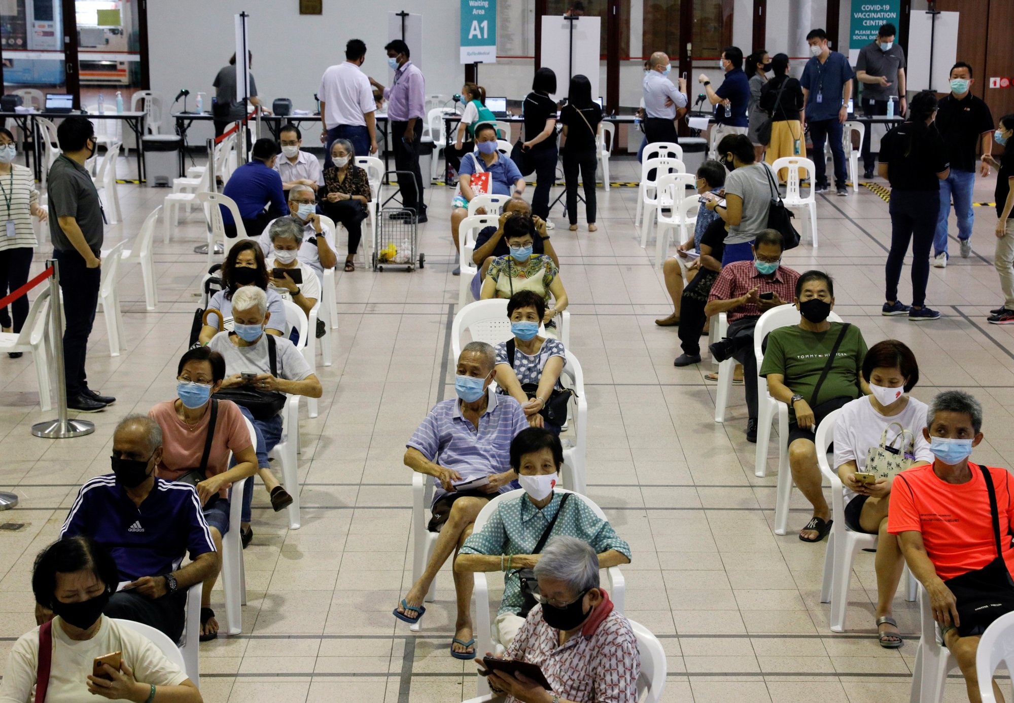 People aged 70 and older wait in an observation area in Singapore after receiving a dose of Covid vaccine in 2021. The health ministry said multiple studies had shown the effectiveness of vaccination in protecting older people. Photo: Reuters