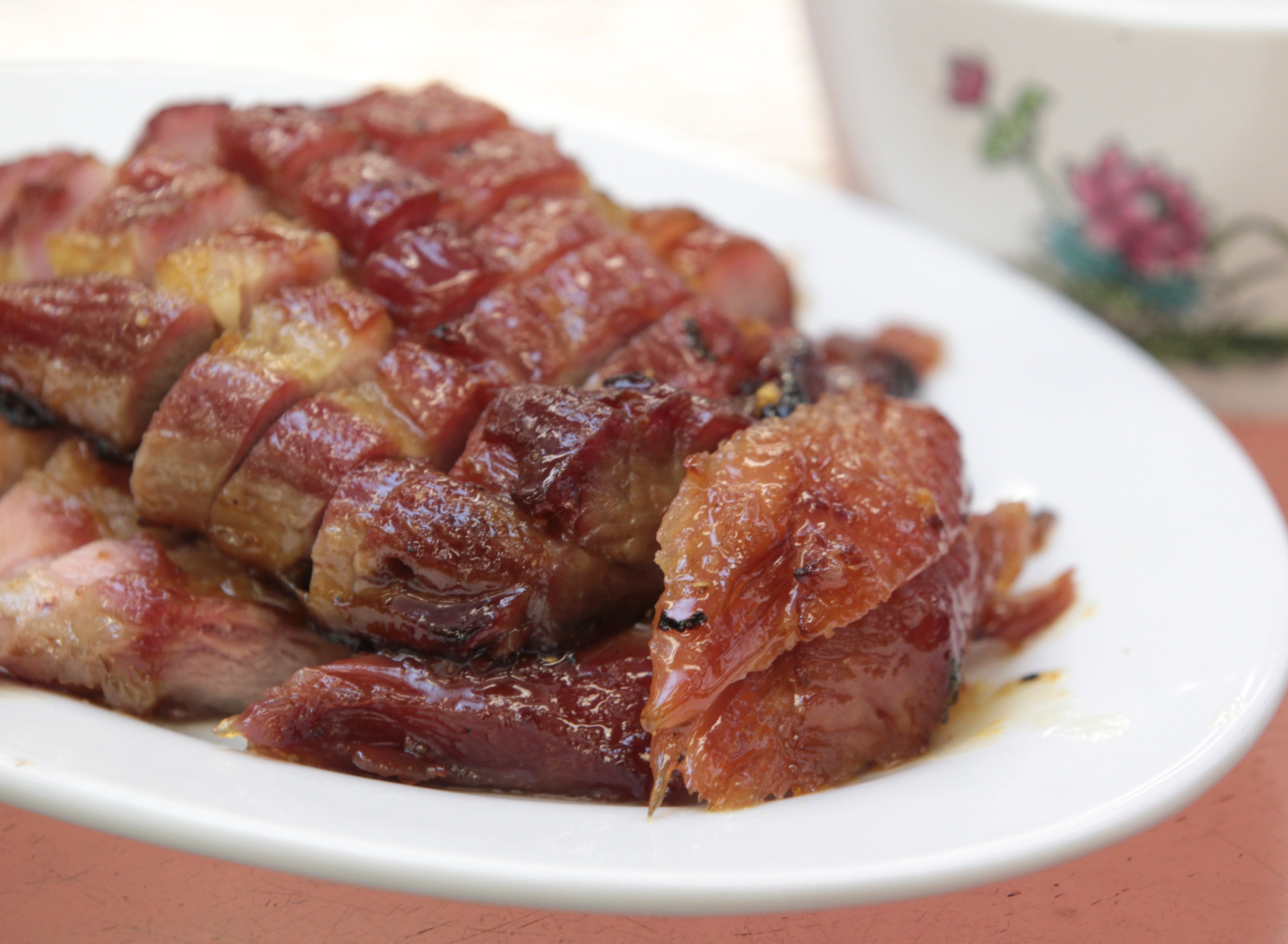 Crystal Jade in Singapore has been feeling the heat for a promotional campaign for char siu (above) that employs a Cantonese insult often directed at children by frustrated parents. Photo: SCMP