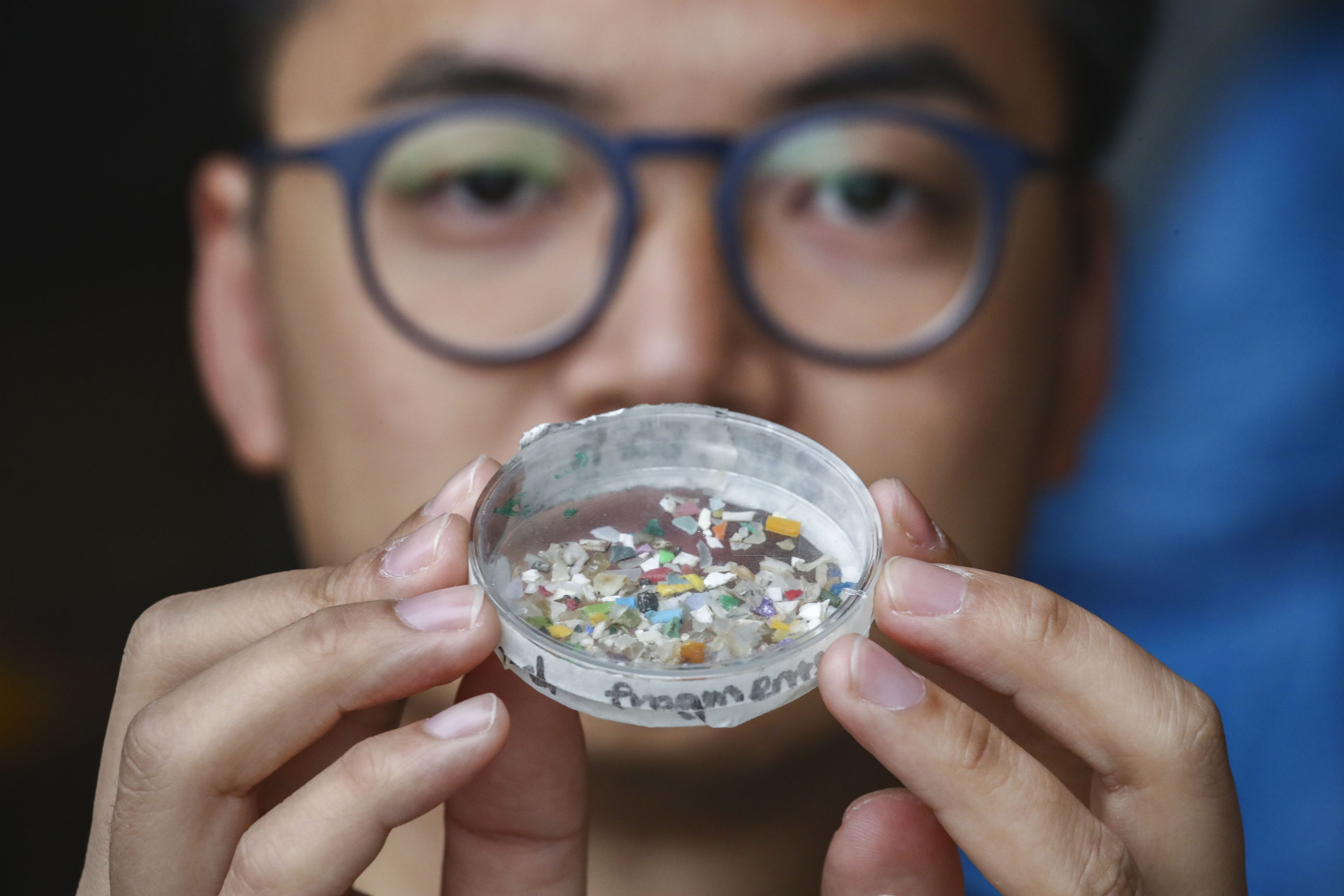 A Greenpeace campaigner shows samples of microplastics collected from the South China Sea. More than 50 per cent of Malaysia’s microplastic consumption comes from fish, the report found. Photo: Nora Tam