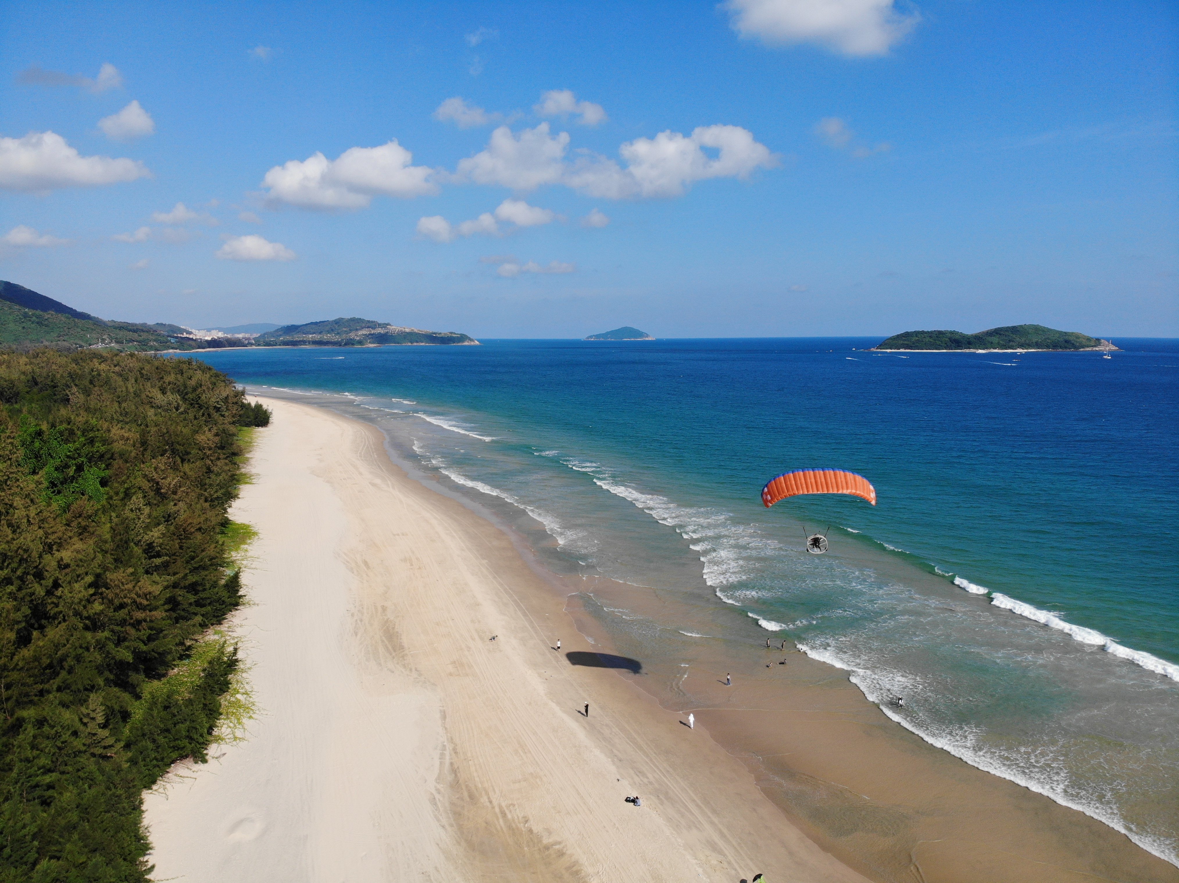A paraglider hovers over a beach in Shimei Bay, Hainan. The island’s “low-altitude economy” is flourishing. Photo: Getty Images