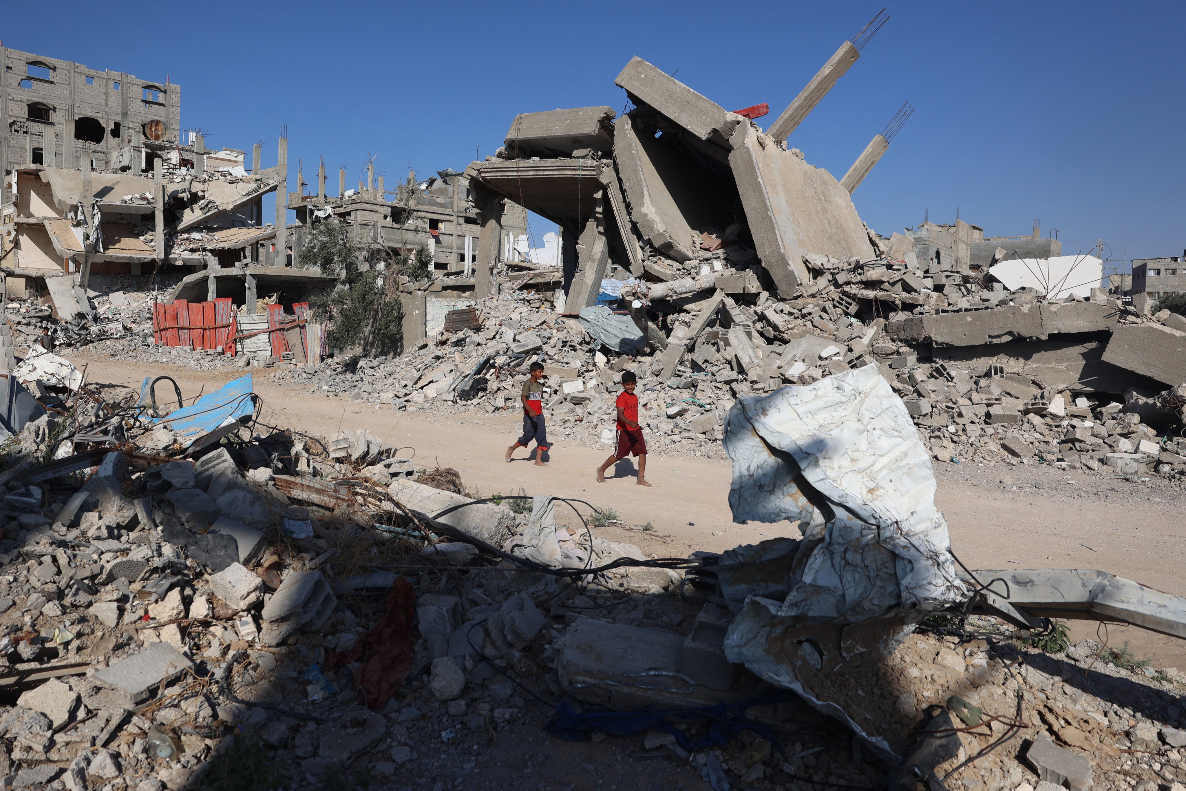 Palestinian boys walk past destroyed buildings in Gaza. Israeli forces have shown a cruel disregard for civilian life there in pursuit of Hamas. Targeting non-combatants is nothing new, as recent Chinese history shows. Photo: AFP