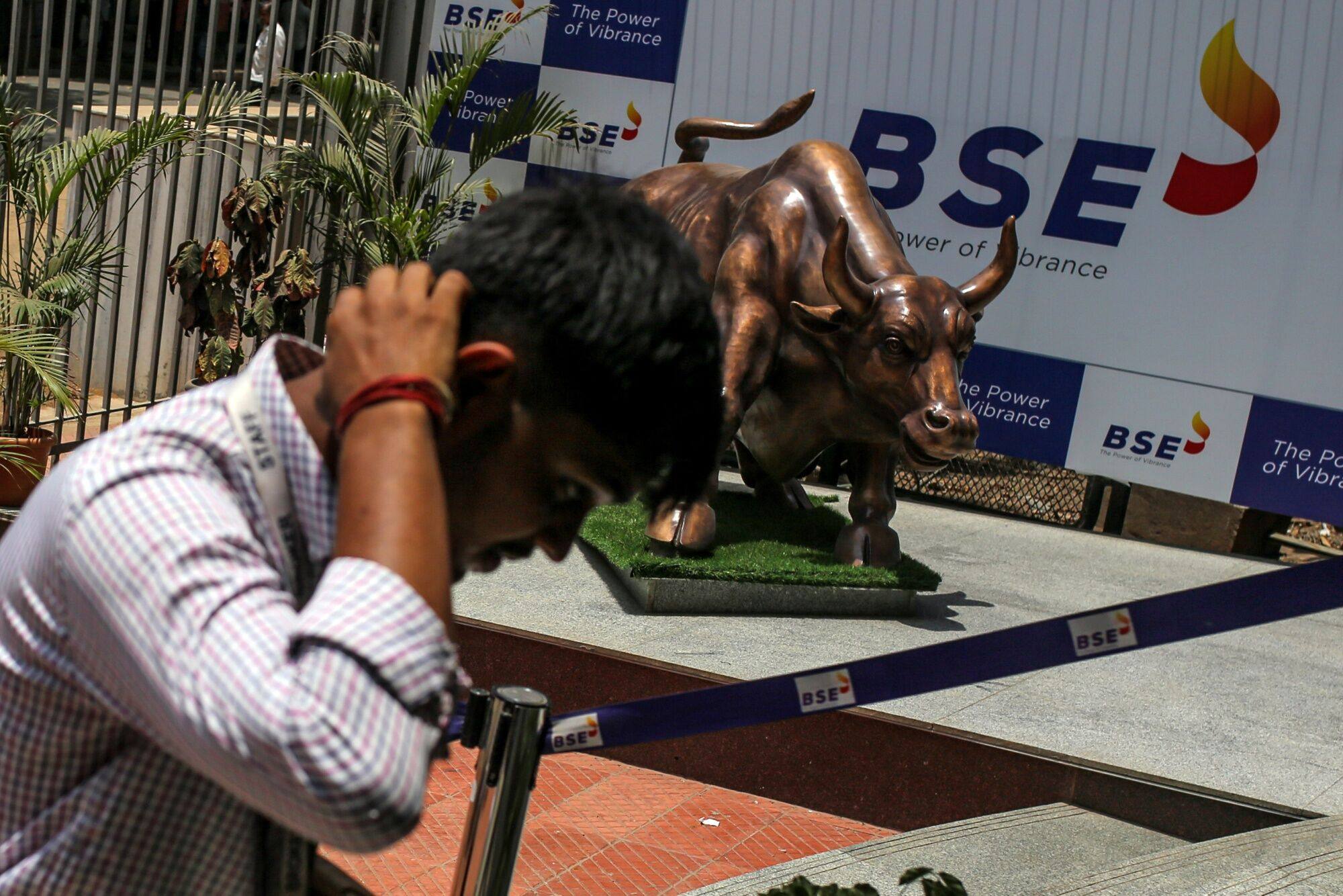 A man walks past a bronze bull statue outside the Bombay Stock Exchange building in Mumbai, India, on June 3. Photo: Bloomberg