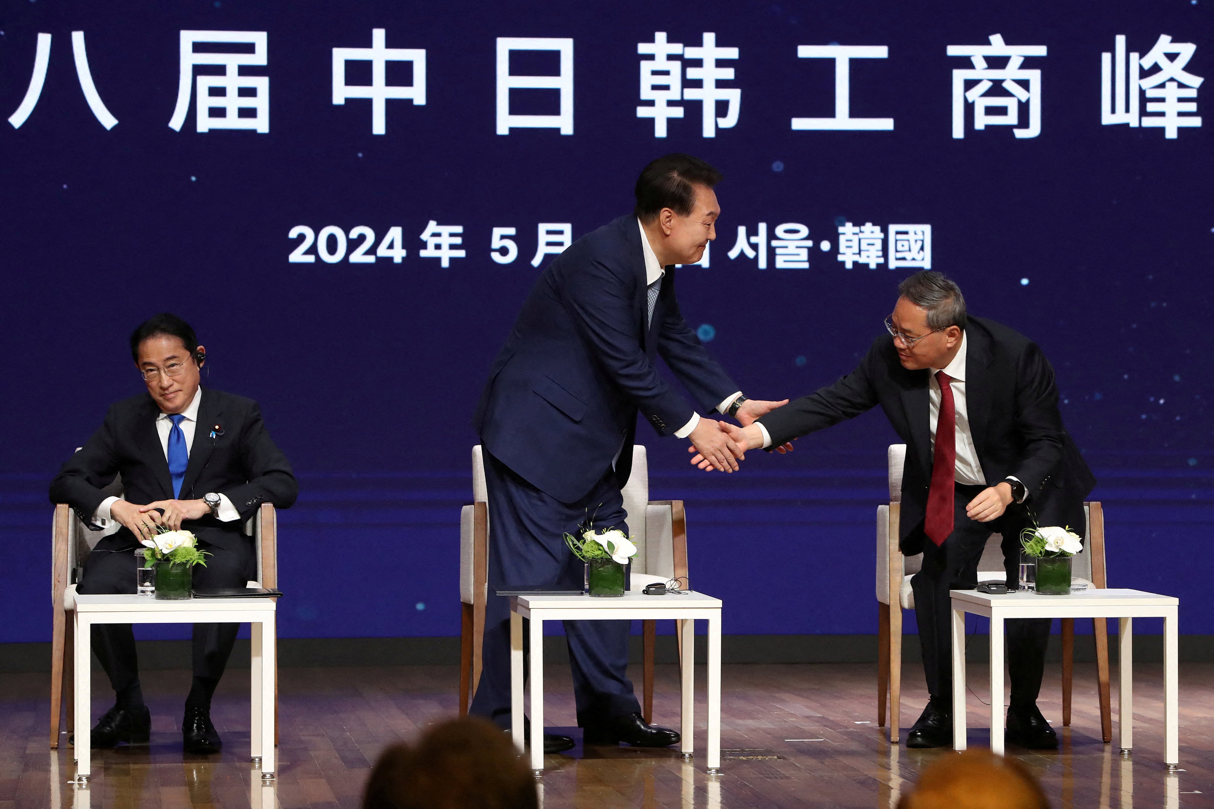 Japanese Prime Minister Fumio Kishida, South Korean President Yoon Suk-yeol and Chinese Premier Li Qiang attend a business summit at the Korea Chamber of Commerce and Industry on May 27 in Seoul, South Korea. Photo: Reuters