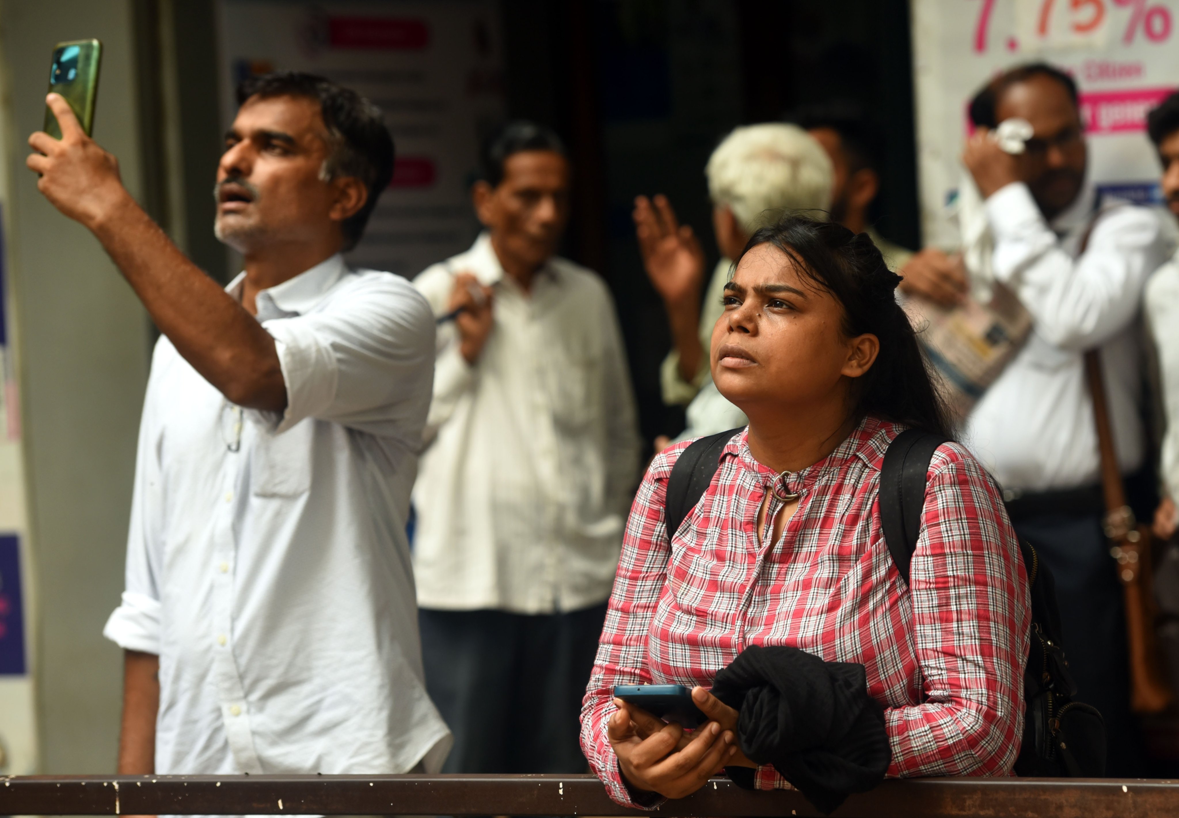 Stock market watchers monitor prices on an electronic board outside the Bombay Stock Exchange building in Mumbai on June 3. Stock prices recorded a high on the back of exit polls forecasting a massive victory for Modi’s party before plunging over the surprise election result. Photo: EPA-EFE