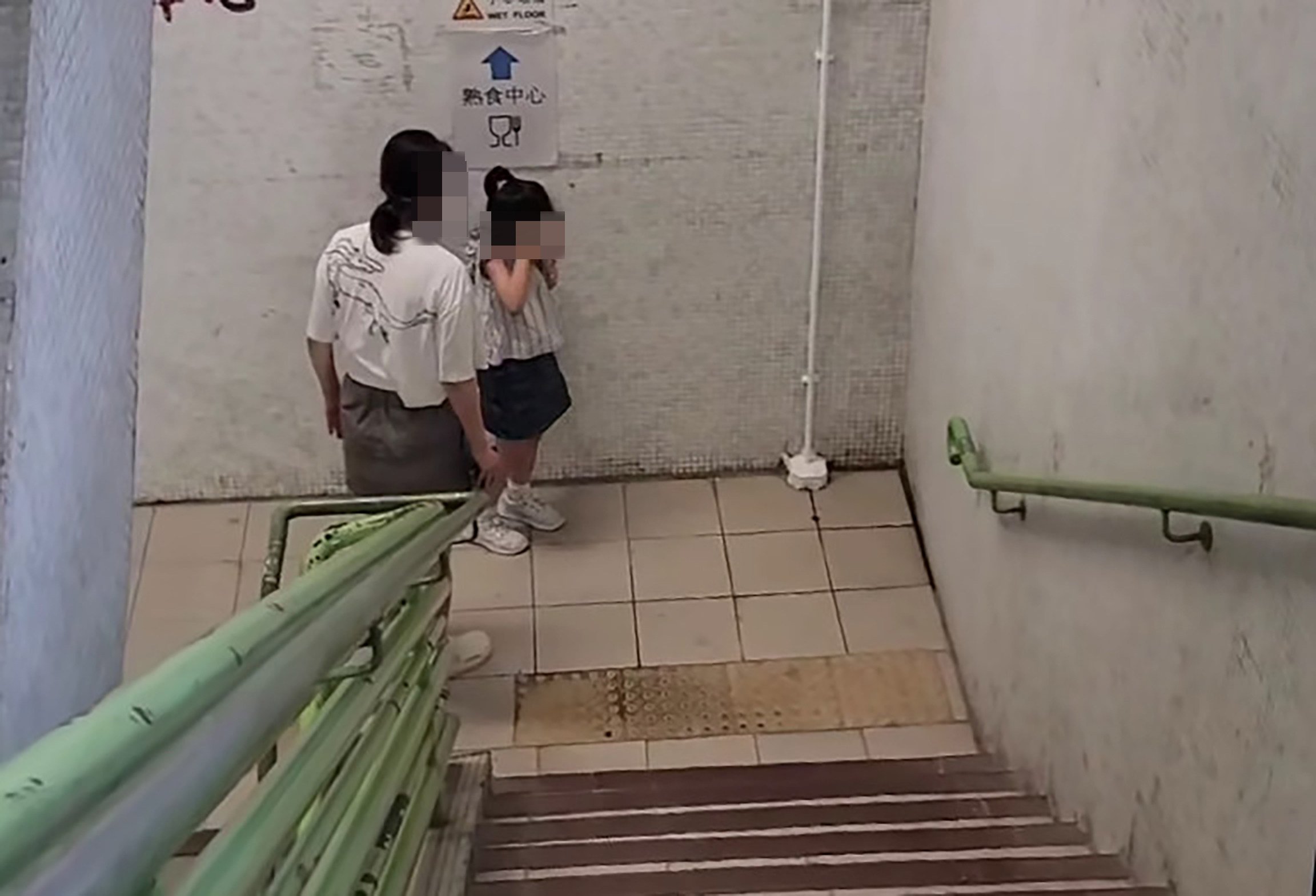The video clip also shows a woman scolding the girl and slapping her on the backstairs of a building. Photo: Facebook/Boll Che Li