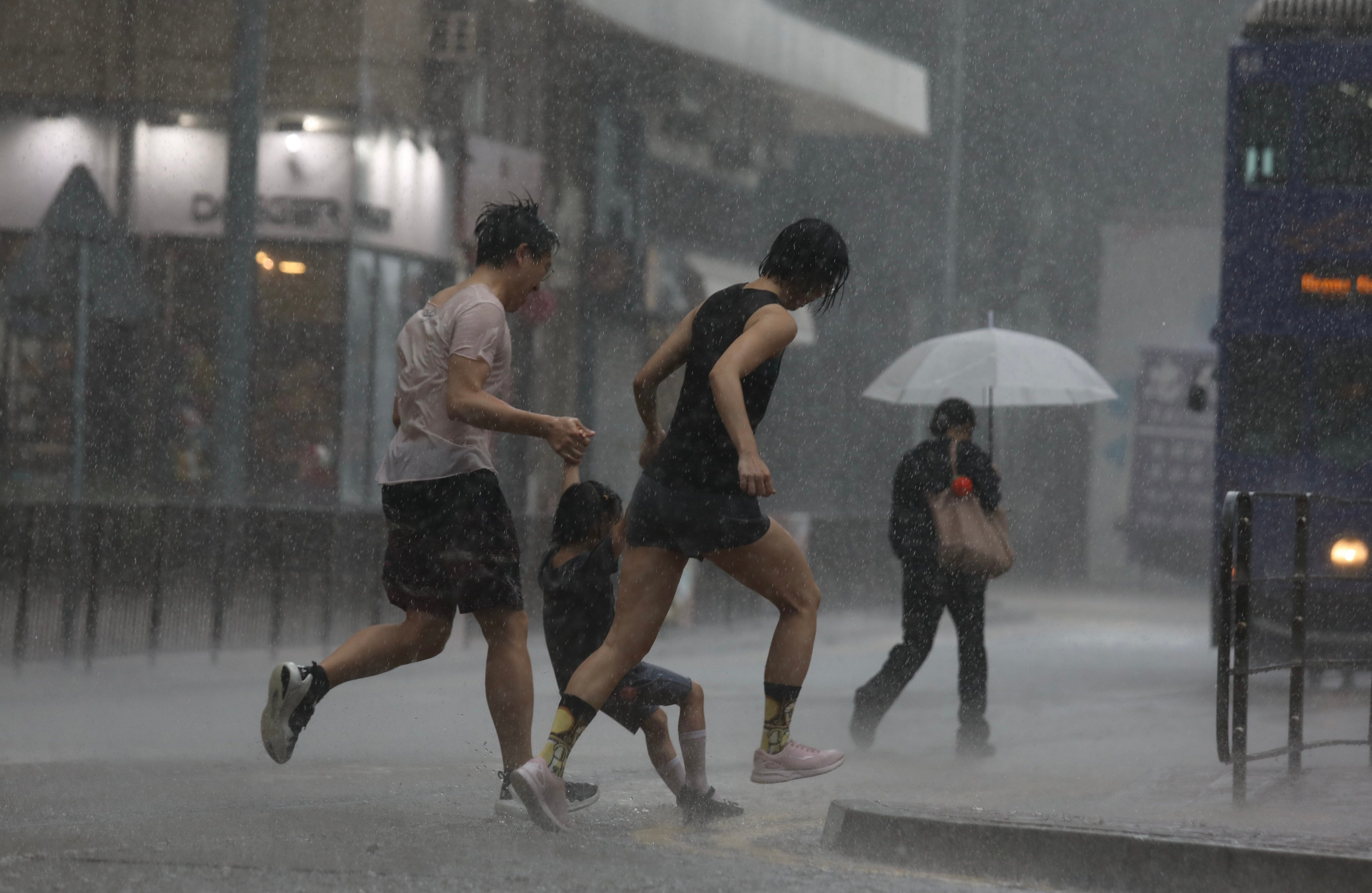 People run in squally weather associated with Typhoon Maliksi in Kennedy Town on June 1. Hong Kong remains a unique and exciting international city in Asia. Photo: Xiaomei Chen