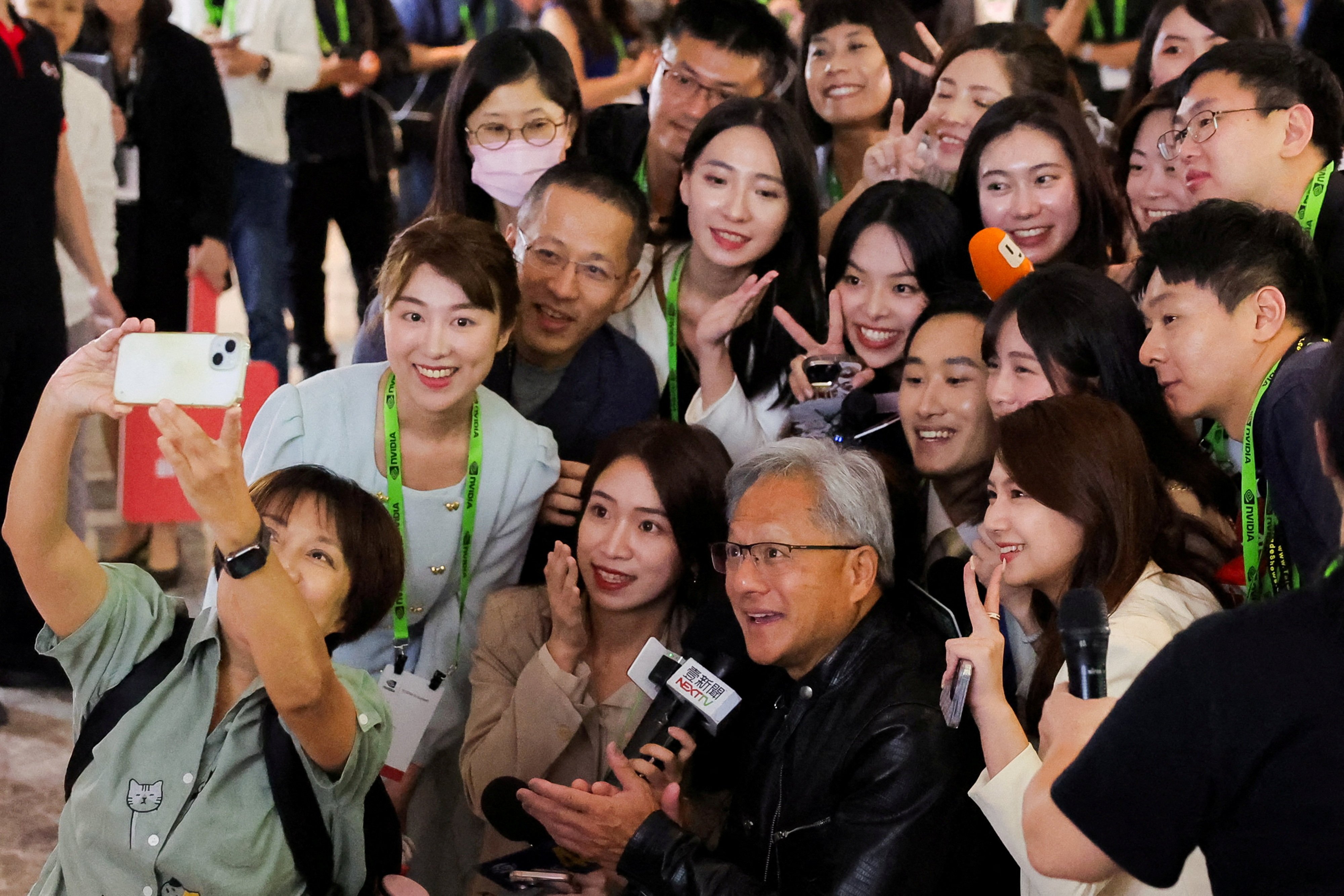 Nvidia CEO Jensen Huang poses for a selfie with members of the media at the Computex Taipei trade show in Taiwan on Tuesday. Photo: Reuters