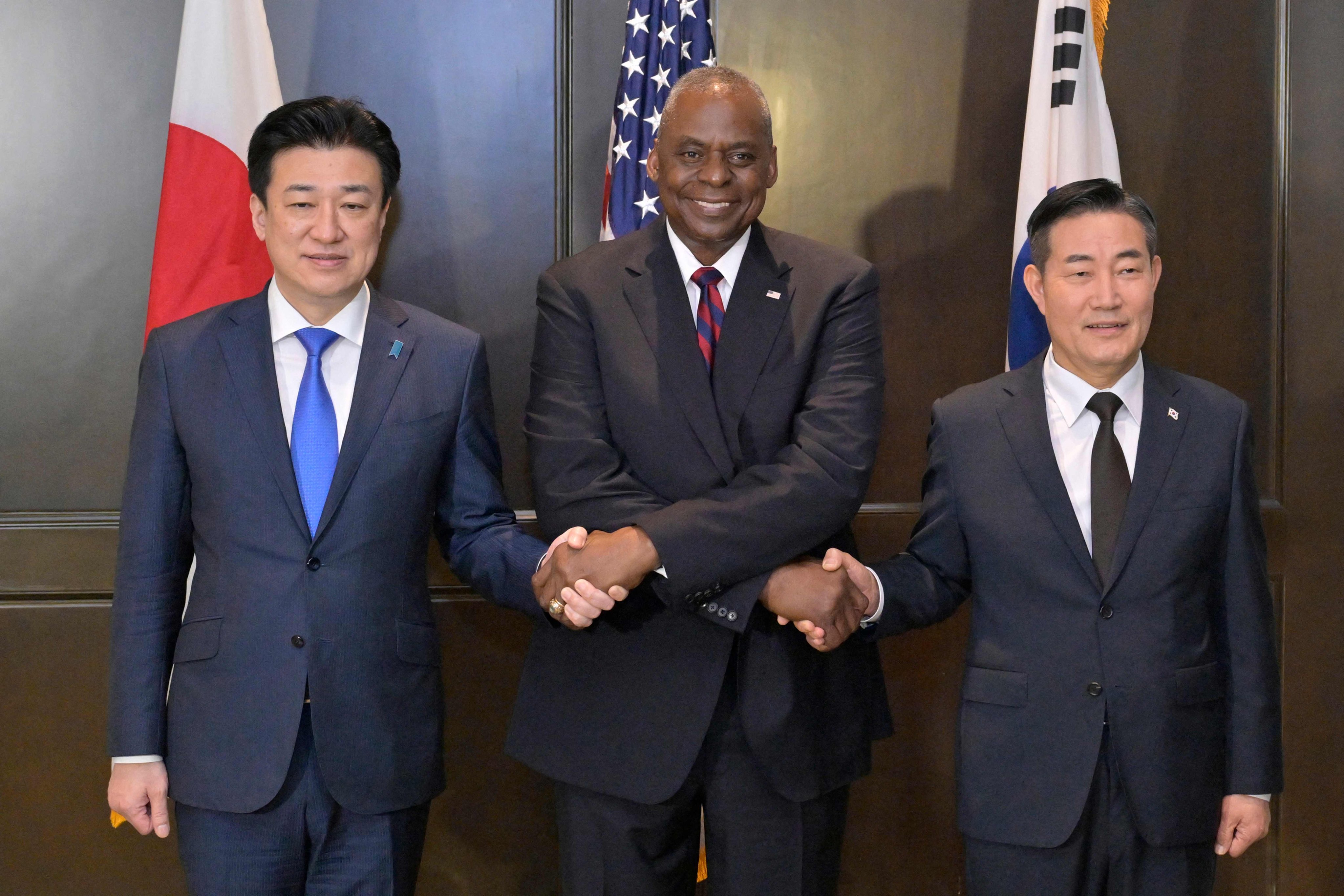 (From left) Japanese, US and South Korean defence chiefs Minoru Kihara, Lloyd Austin and Shin Won-sik meet on the sidelines of the Shangri-La Dialogue in Singapore on Sunday. Photo: AFP