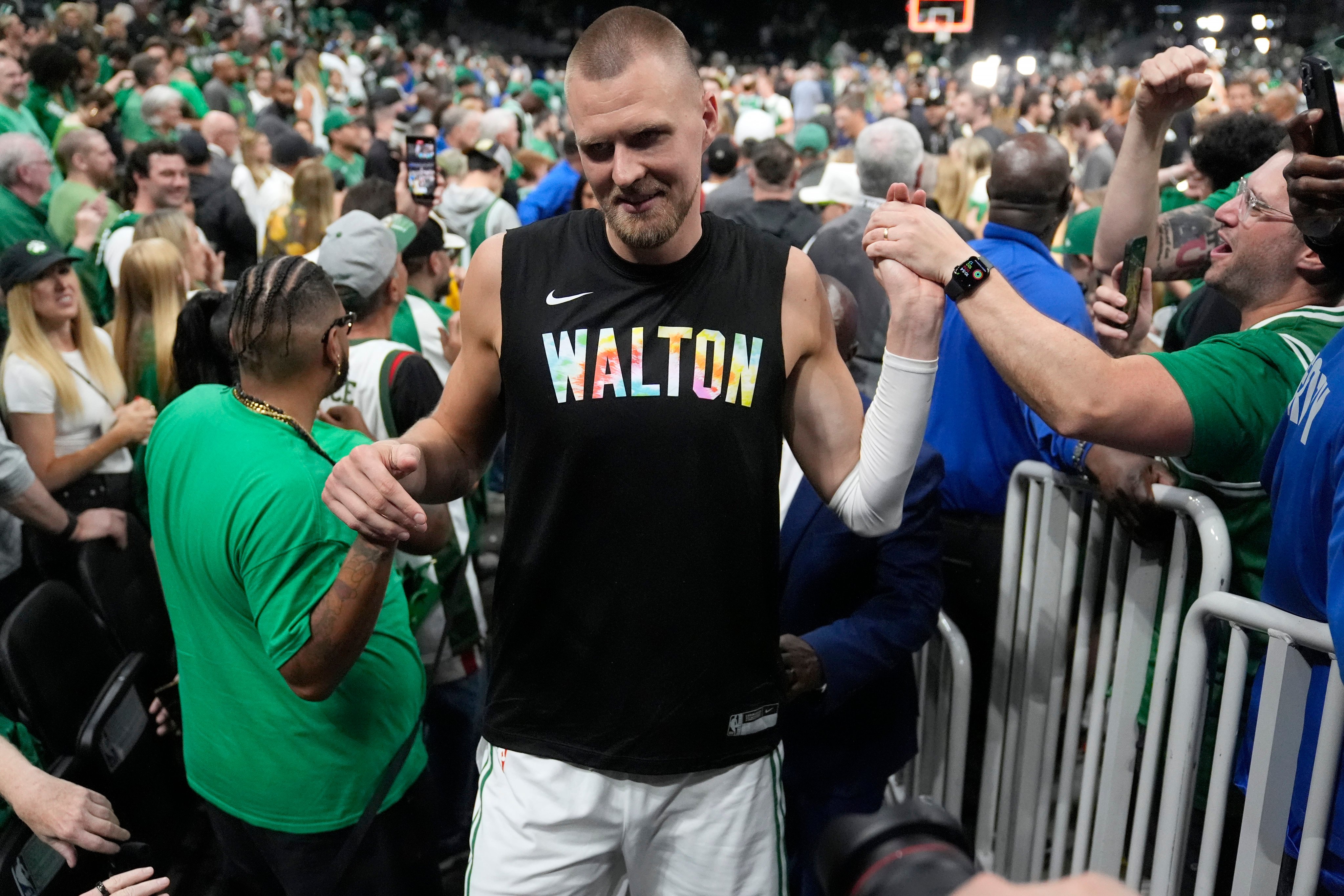 Boston Celtics centre Kristaps Porzingis celebrates with fans after Game 1. Photo: AP