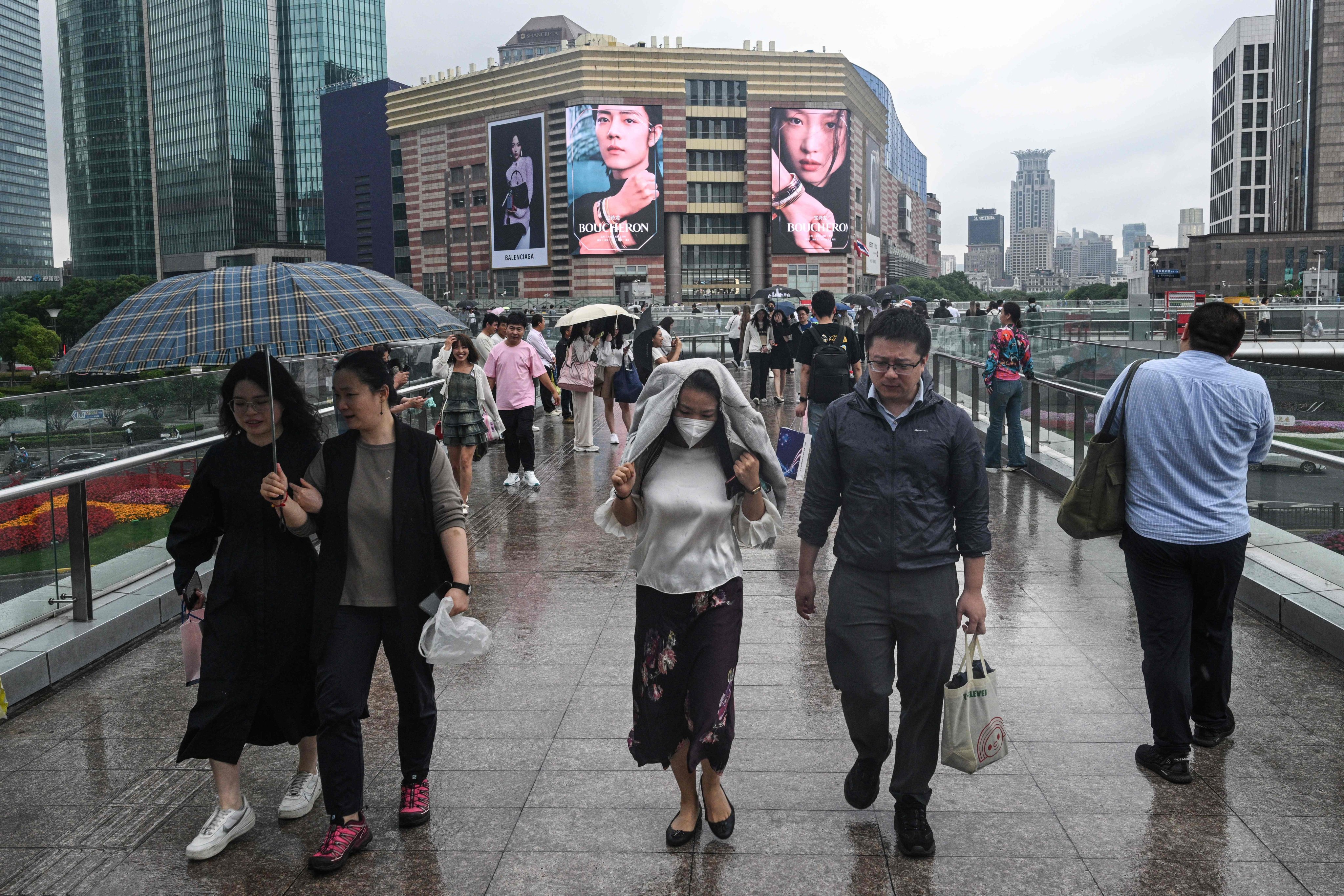 People walk on a bridge in the Lujiazui financial district in Shanghai on June 5, 2024. Photo: AFP