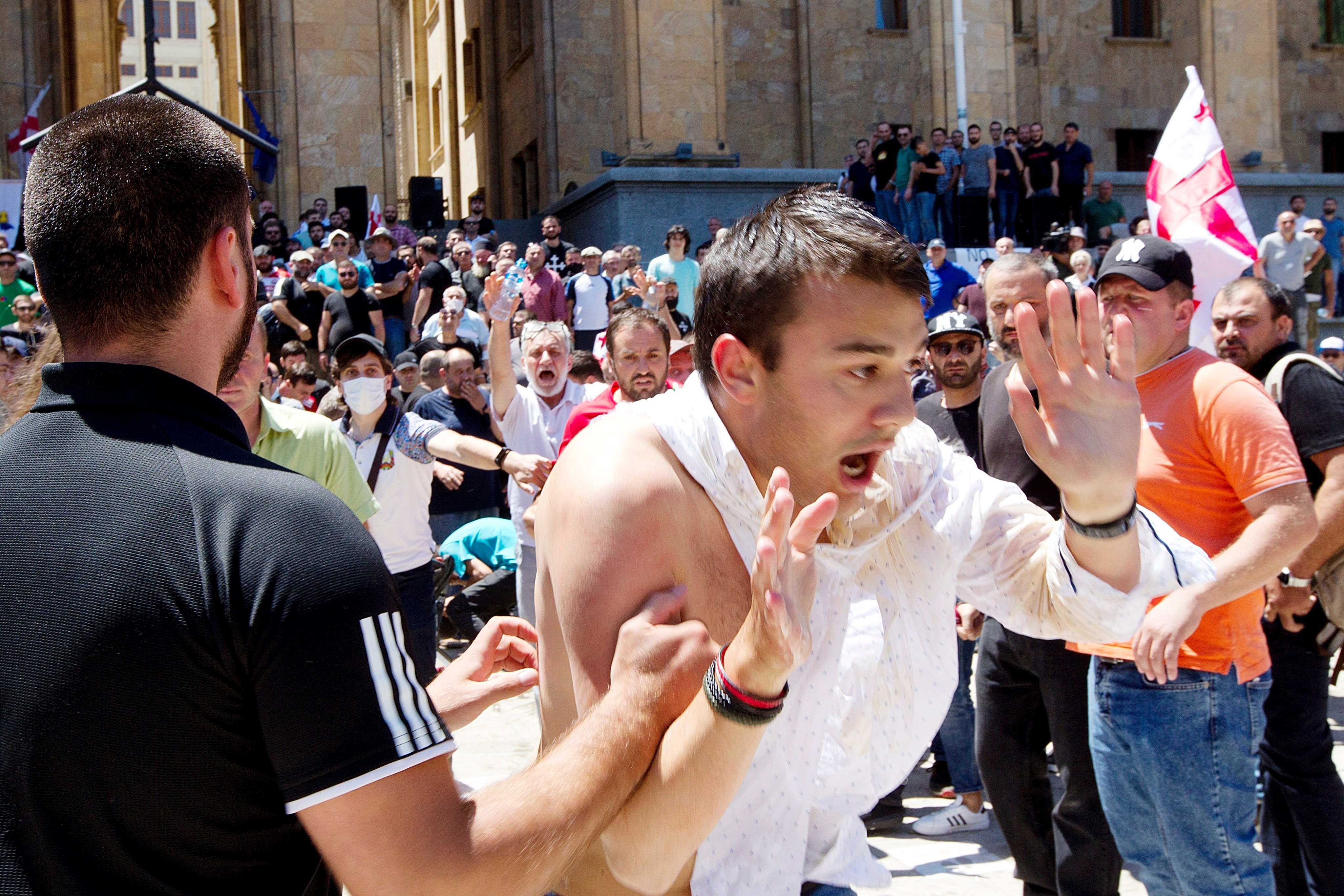 LGBTQ opponents push a man as they block the capital’s main avenue to a pride march in Tbilisi, in 2021. Photo: AP