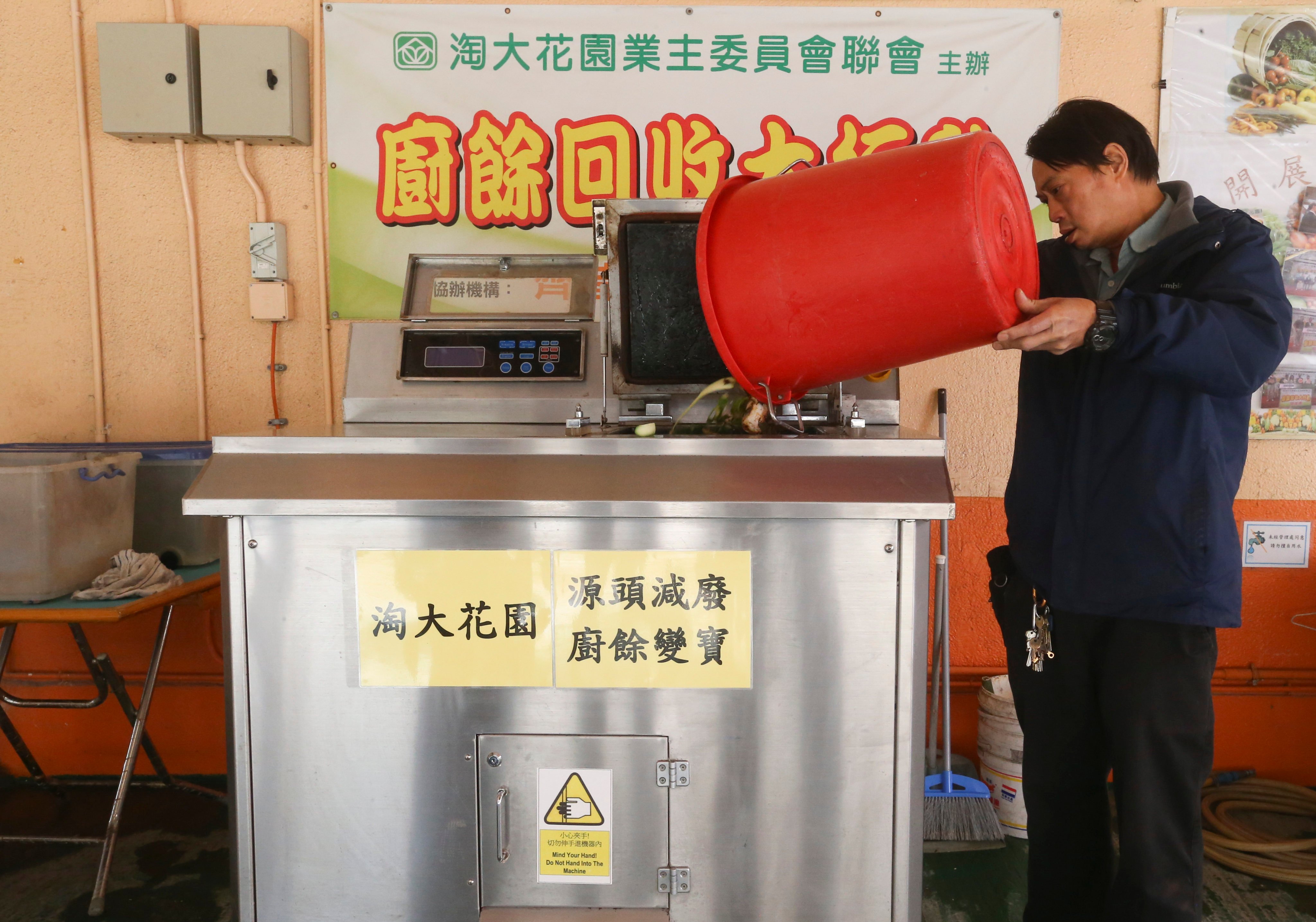 A worker uses a food waste composter at a housing estate in Kowloon in Hong Kong in 2017. Recent discussions of waste management in Hong Kong have largely overlooked the benefits of composting. Photo: K.Y. Cheng