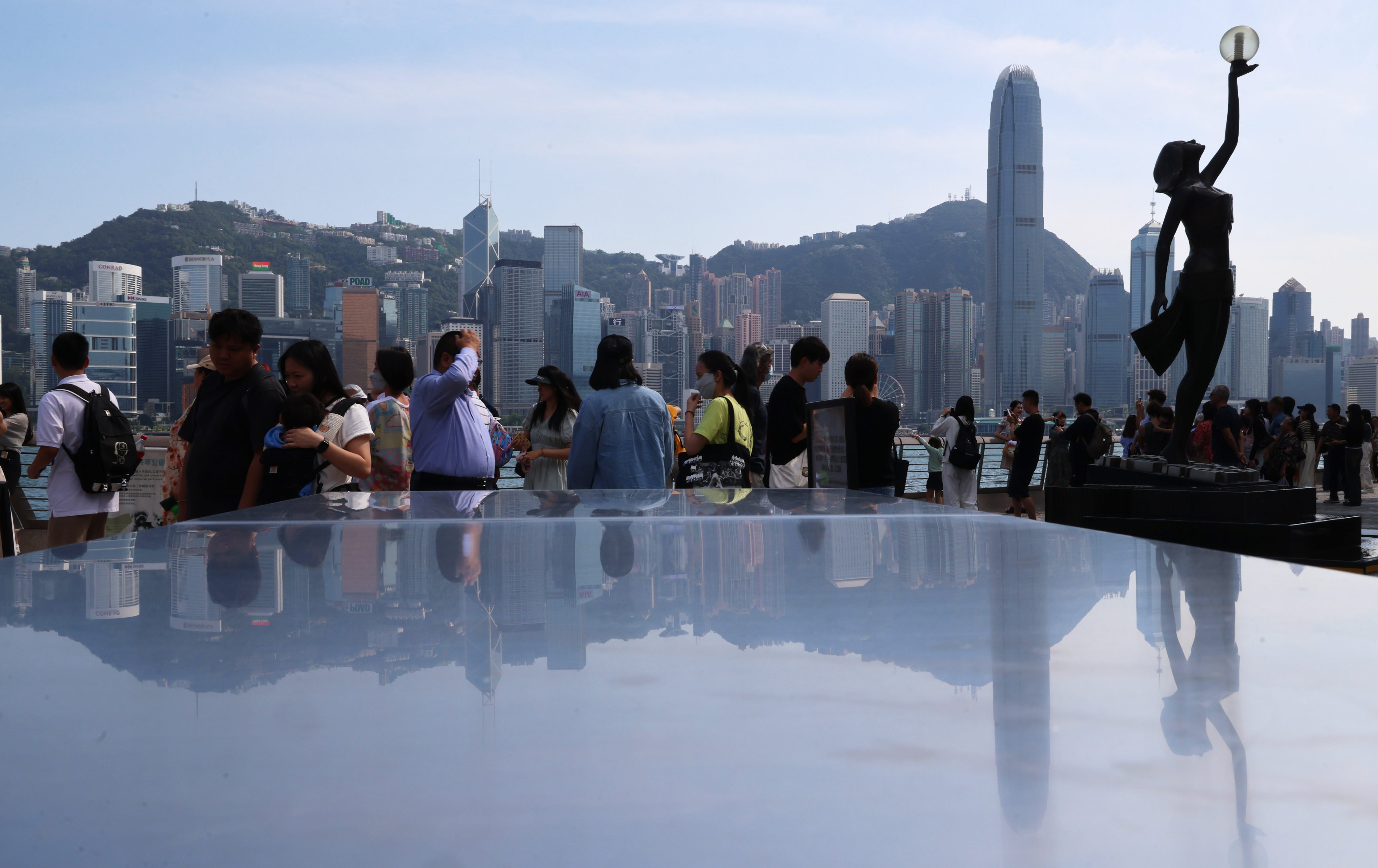 Visitors take in the harbour view along the Tsim Sha Tsui waterfront on May 15. Photo: Jelly Tse