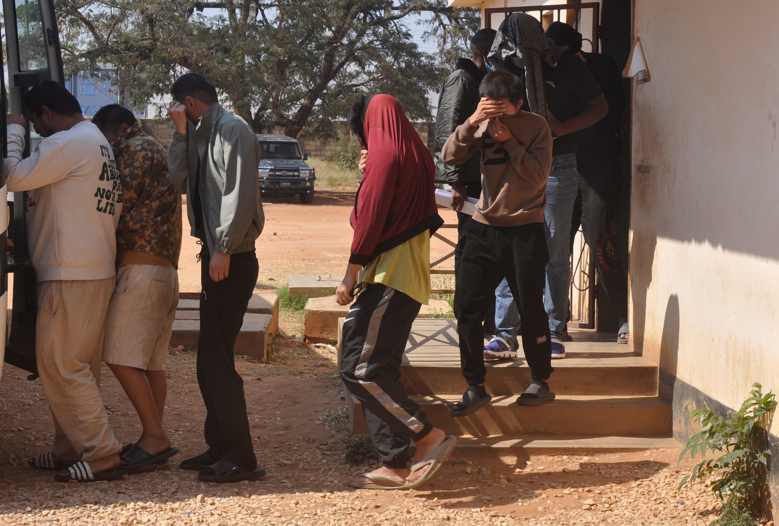 A group of Chinese nationals is seen outside court in Lusaka, Zambia, on Friday. Photo: AP