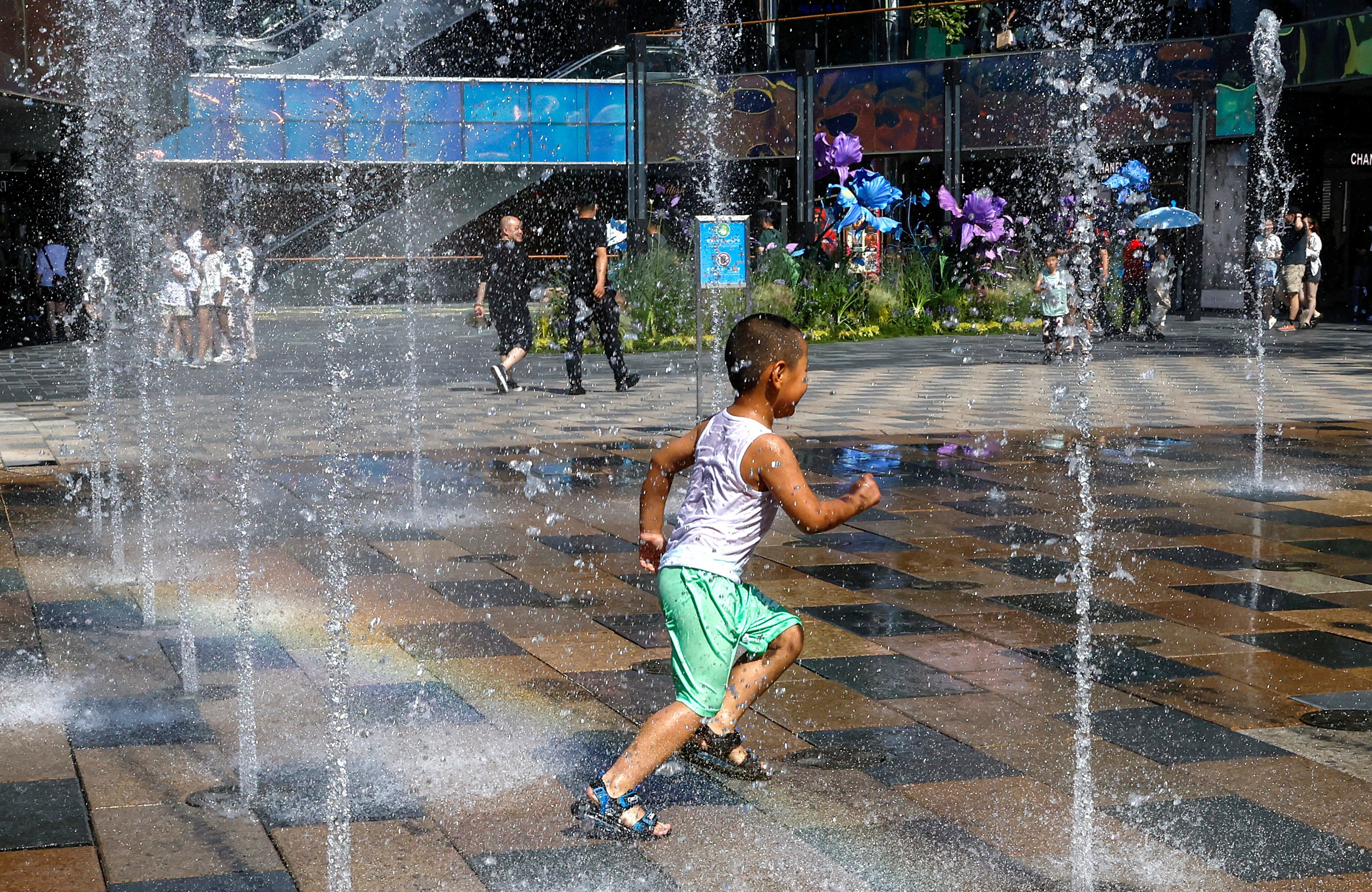 A child cools down in a fountain during last year’s heatwave in Beijing. Photo: Reuters