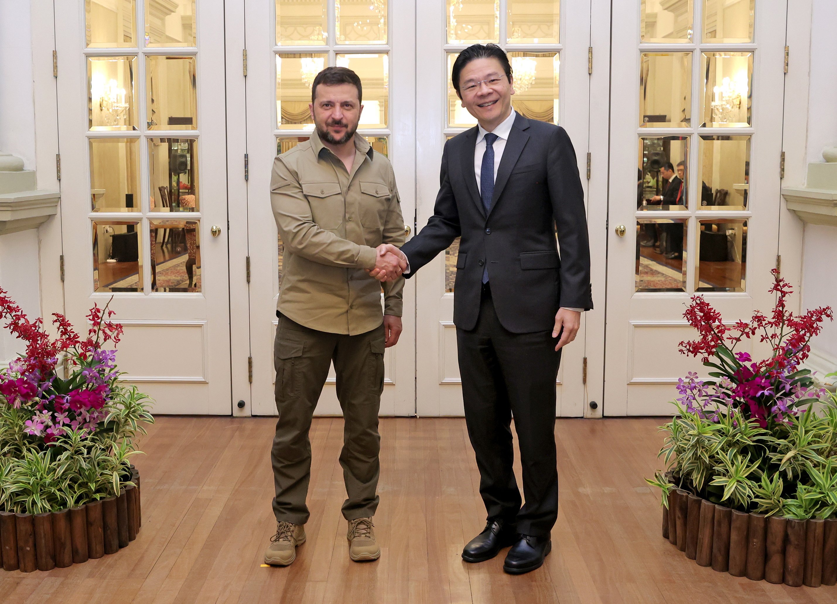 Singapore Prime Minister Lawrence Wong shaking hands with Ukraine President Volodymyr Zelensky during their meeting at the Istana or Presidential Palace on June 2, 2024. Photo: EPA-EFE