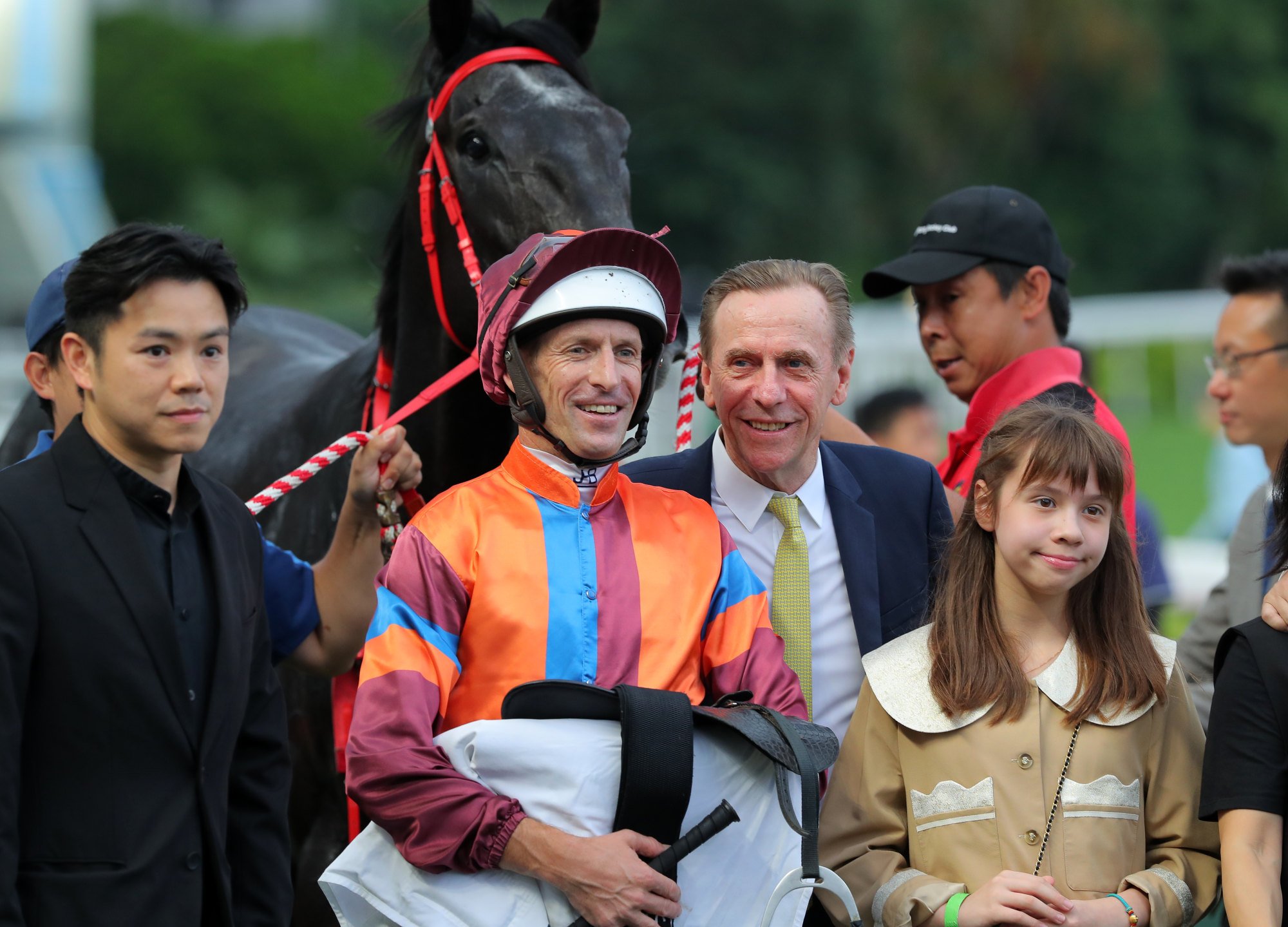 Hugh Bowman, John Size and connections of The Winnabe celebrate the gelding’s Sha Tin victory.