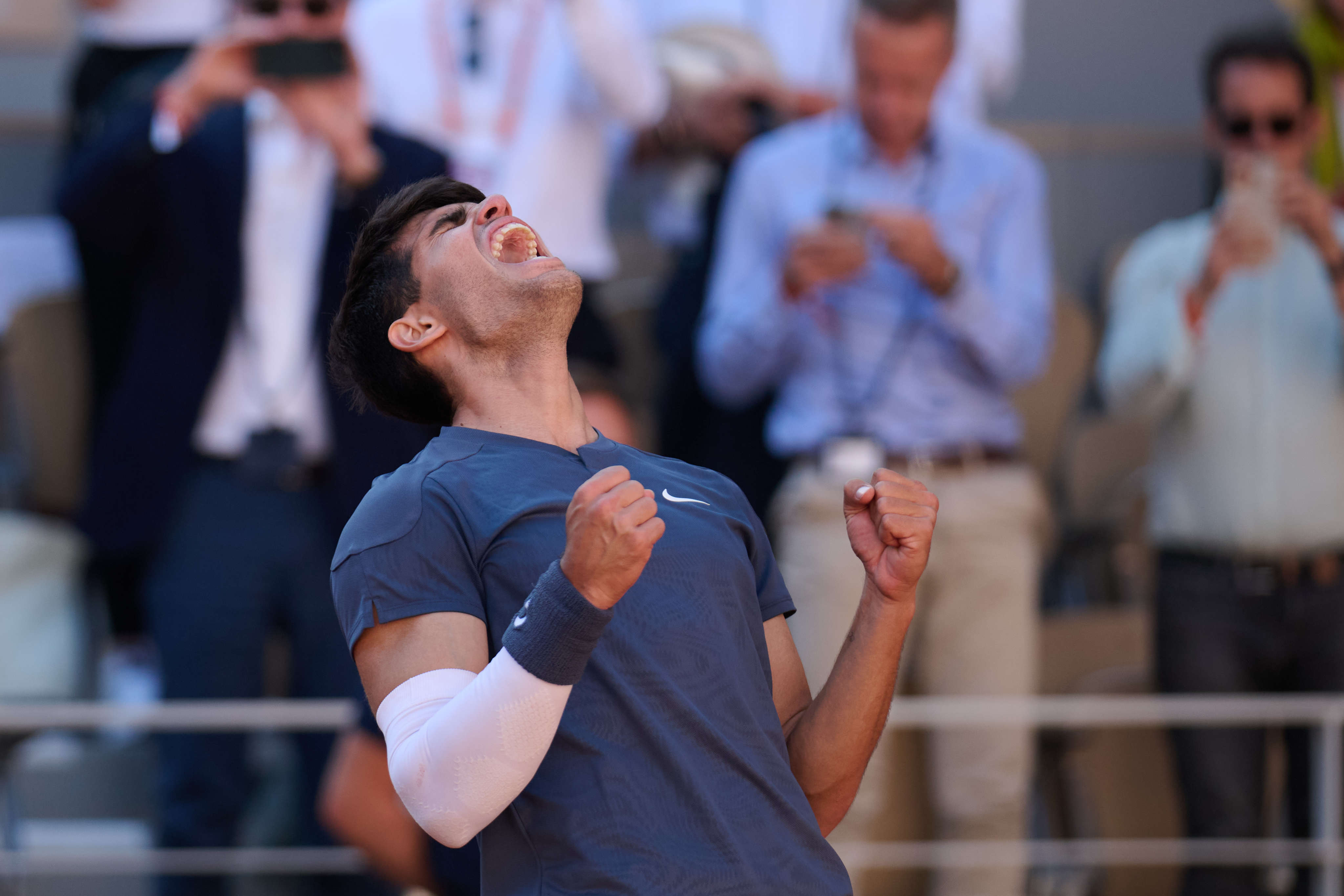 Carlos Alcaraz shows his joy and relief after overcoming Jannik Sinner in a five-set thriller. Photo: Xinhua