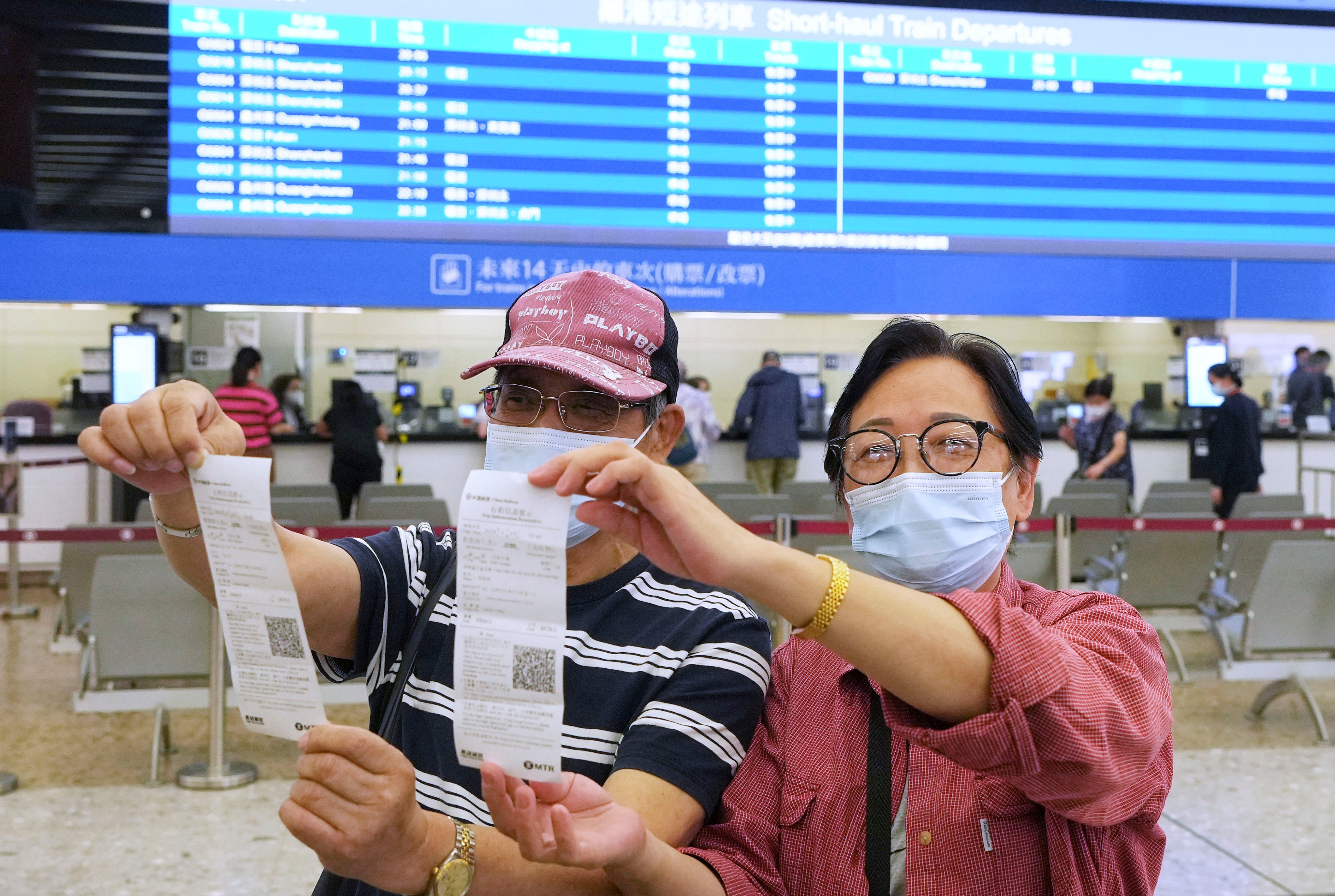 Customers flaunt their tickets for the new high-speed sleeper train service on the first day of sales. Photo: Elson Li