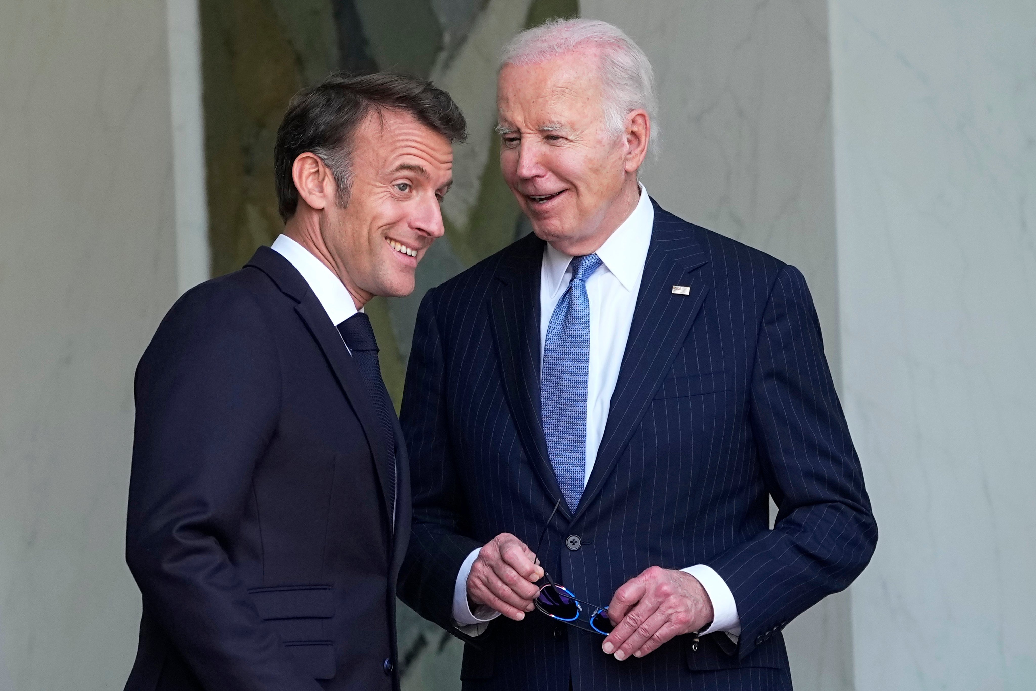 US President Joe Biden (right) smiles with French President Emmanuel Macron after their talks at the Elysee Palace in Paris on Saturday. Photo: AP