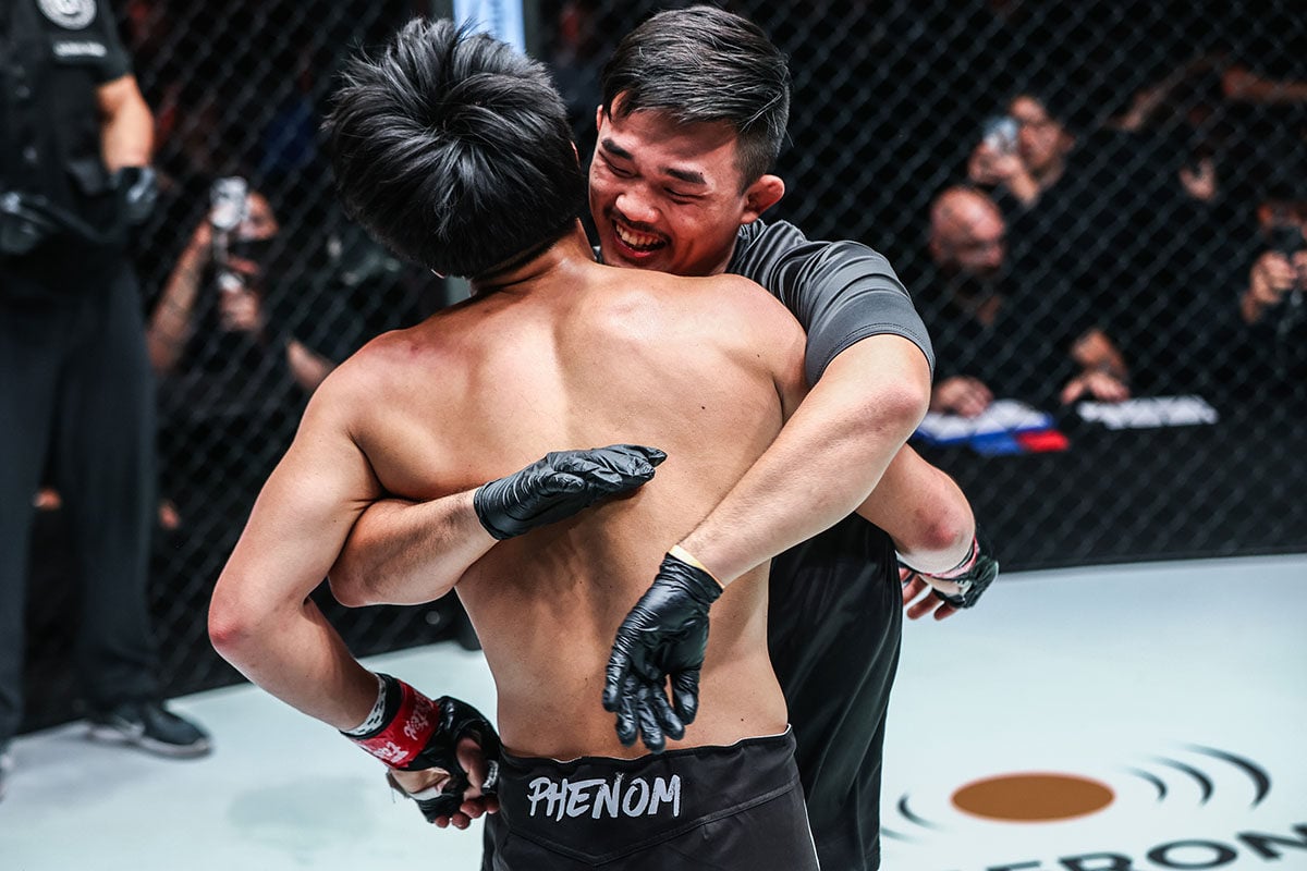 Christian Lee (right) hugs younger brother Adrian after the latter won his professional debut against Antonio Mammarella in Bangkok last Saturday. Photo: ONE Championship