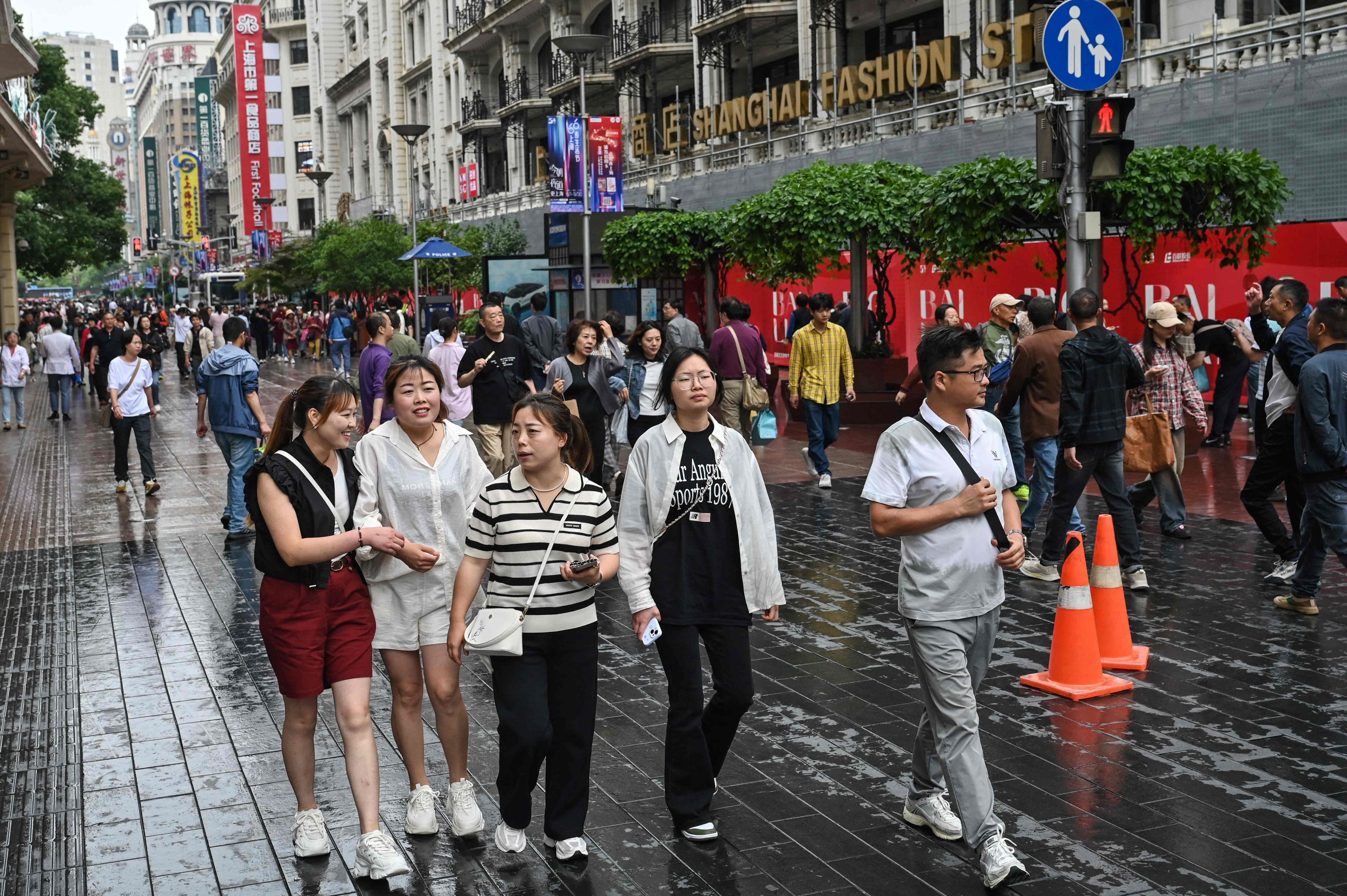 People walk on a pedestrian street surrounded by shops in the Huangpu district of Shanghai on June 6, 2024. Photo: AFP