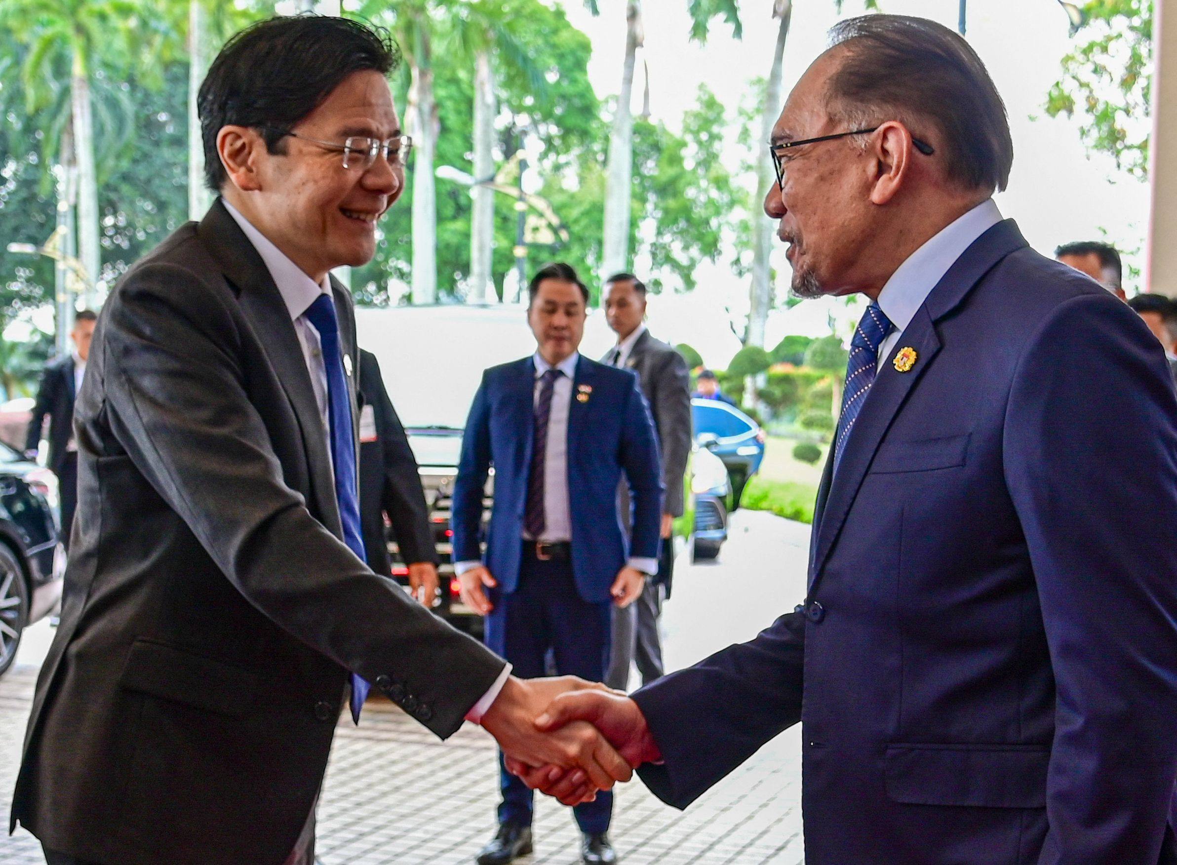 Malaysia’s Prime Minister Anwar Ibrahim and Singapore’s Prime Minister Lawrence Wong shaking hands ahead of their meeting in Putrajaya. Photo: AFP